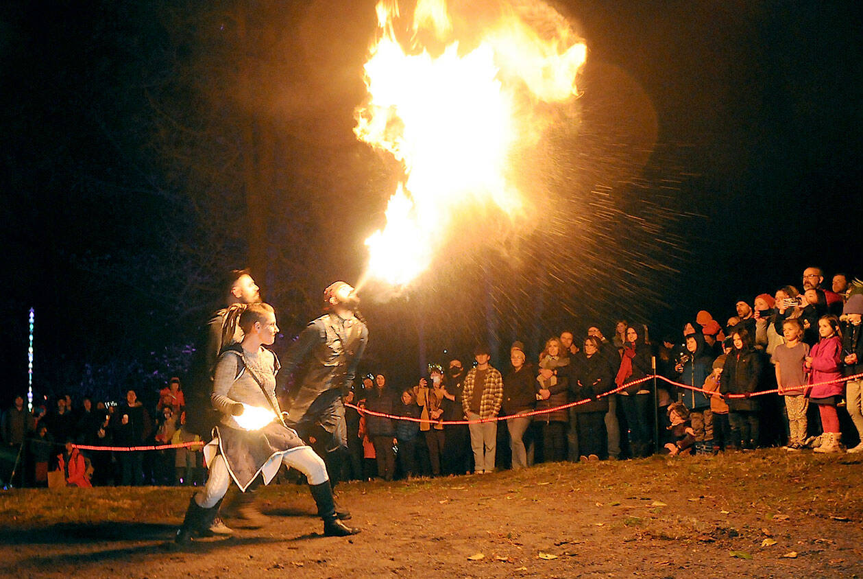 Members of The Fractal Phase, from front, Nova Cain, Pumba Burns and Ahnrix Bishop, breathe fire and preform dance with flames during Saturday’s Wintertide Festival of Light at the Port Angeles Fine Arts Center. The event featured music, entertainment, a lantern parade and other yule activities to celebrate the winter solstice. (Keith Thorpe/Peninsula Daily News)