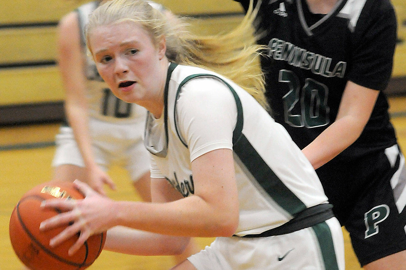 KEITH THORPE/PENINSULA DAILY NEWS
Port Angeles's Paige Mason, front, looks for an out as Peninsula's Ashley Edmonds closes in during Saturday's game at Port Angeles High School.