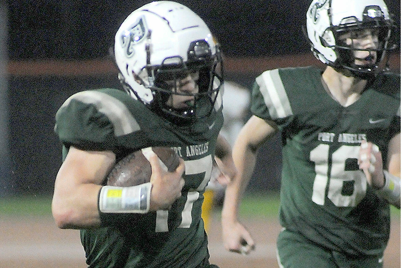 KEITH THORPE/PENINSULA DAILY NEWS
Port Angeles' Jason Hawes, left, takes a punt return from deep in Roughrider territory for a second quarter touchdown against Kingston as teammate Blake Sohlberg follows behind on Friday at Port Angeles Civic Field.