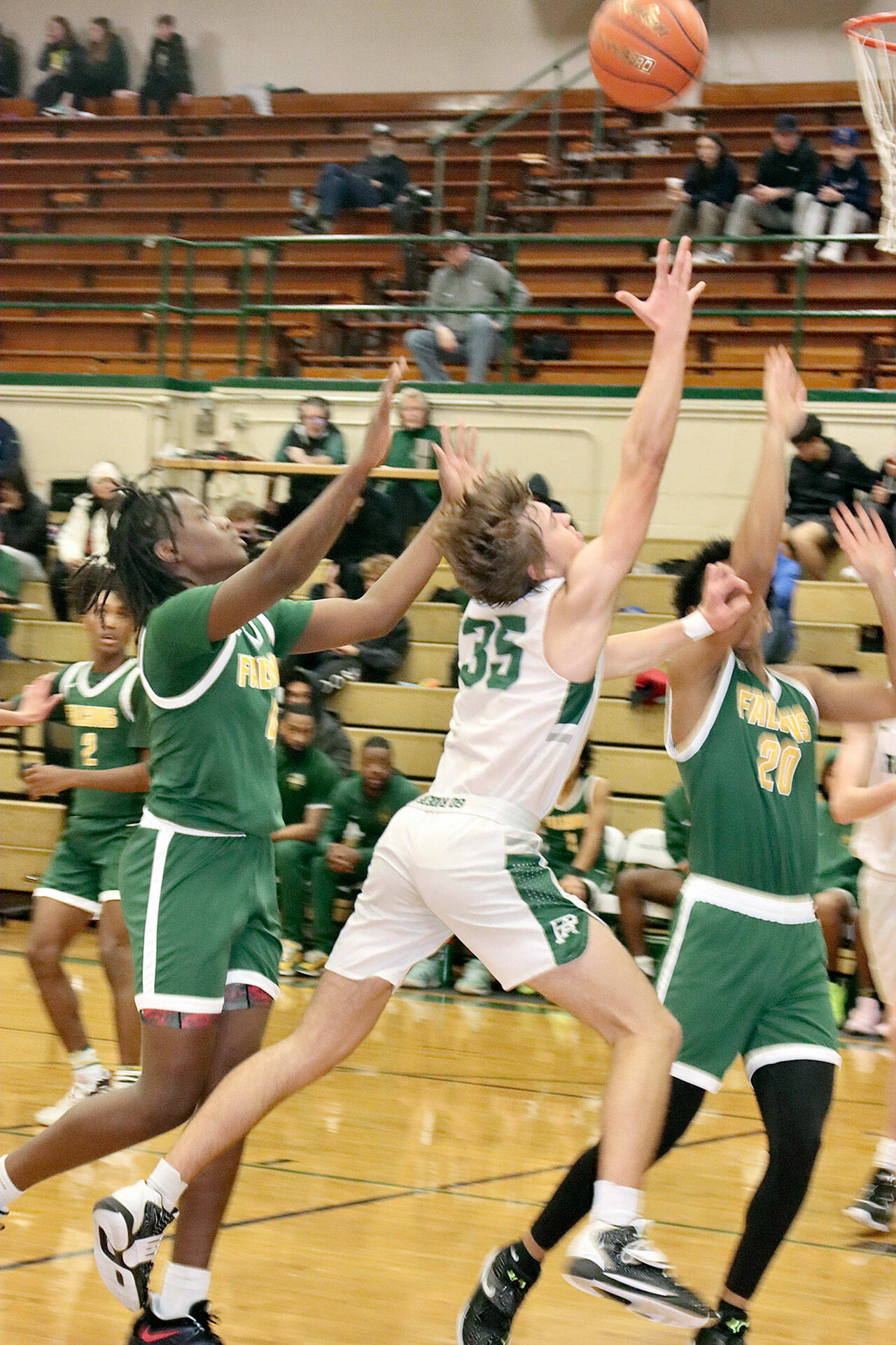 Dave Logan/for Peninsula Daily News Port Angeles’ Parker Nickerson (35) splits Foss defenders Nathanial Campbell and Jonathan Martin on a layin attempt during Thursday’s contest at Port Angeles High School.
Port Angeles’ Parker Nickerson (35) splits Foss defenders Nathanial Campbell and Jonathan Martin on a layin attempt during Thursday’s contest at Port Angeles High School. (Dave Logan/for Peninsula Daily News)