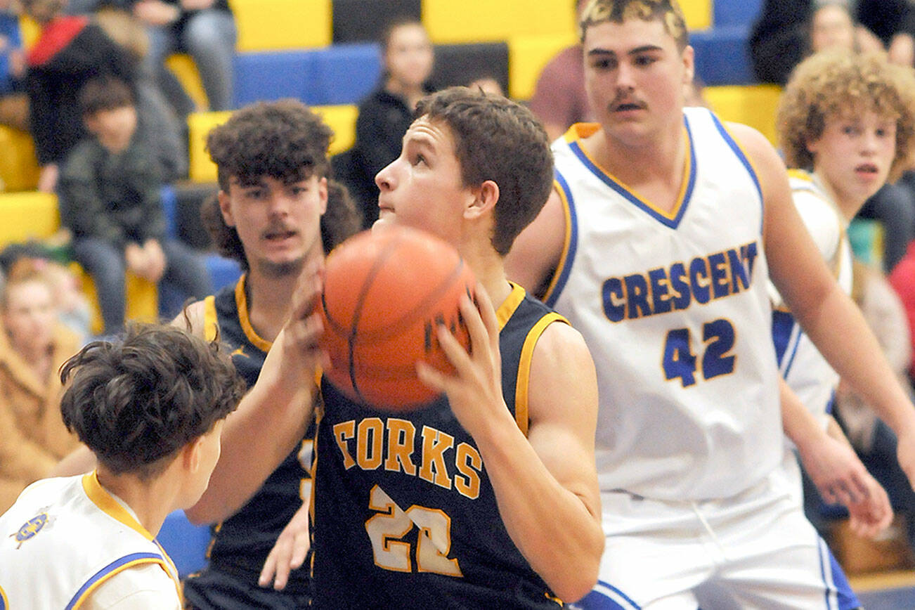 KEITH THORPE/PENINSULA DAILY NEWS
Forks' Brody Lausch, center, looks for an opening surrounded by, clockwise from left, Terrell Emery of Crescent, LandinDavis of Forks, and Conner Ferro-May and Henry Bourm of Crescent on Wednesday in Joyce.