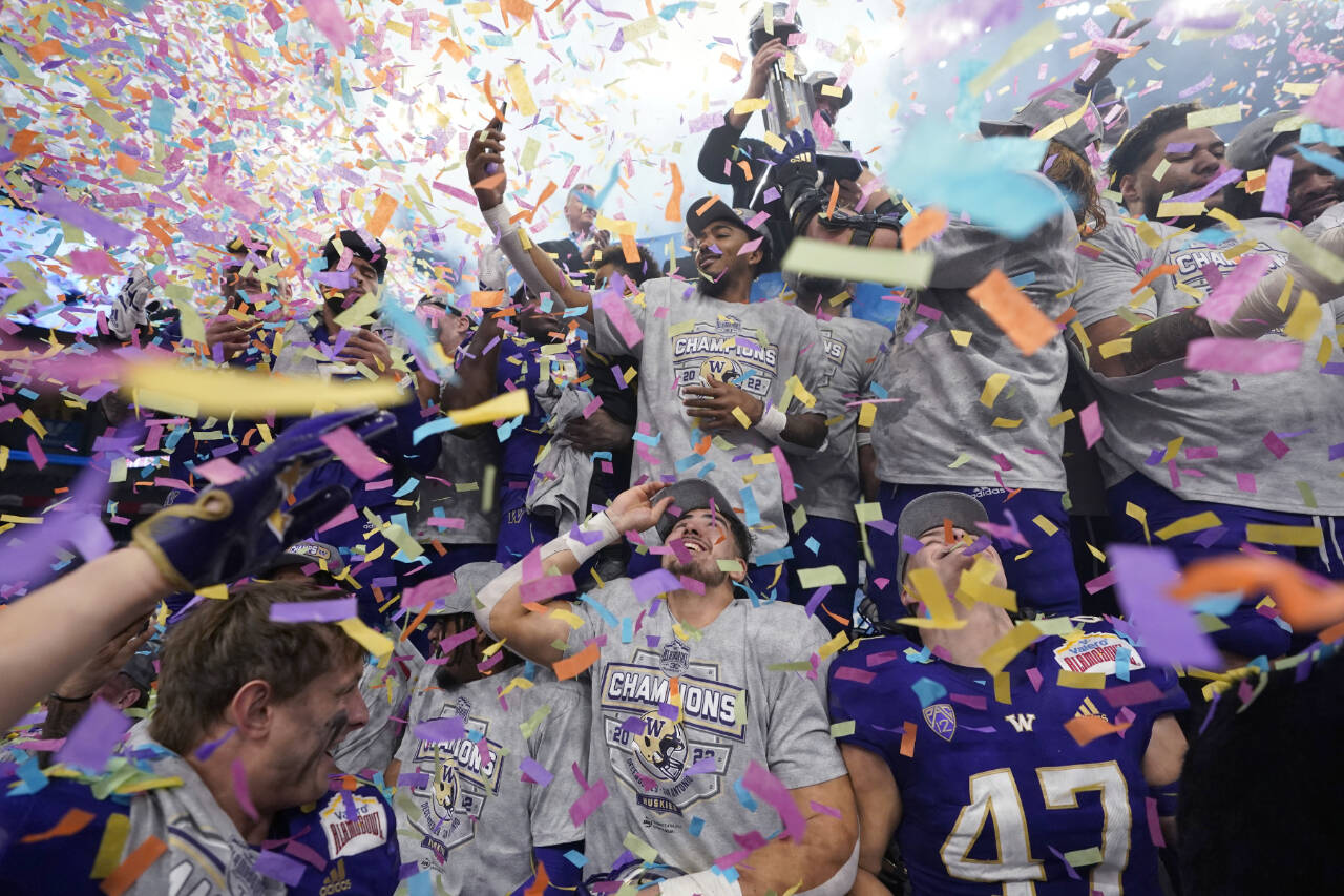 Washington players celebrate their win over Texas in the Alamo Bowl NCAA college football game in San Antonio, Thursday, Dec. 29, 2022. (AP Photo/Eric Gay)