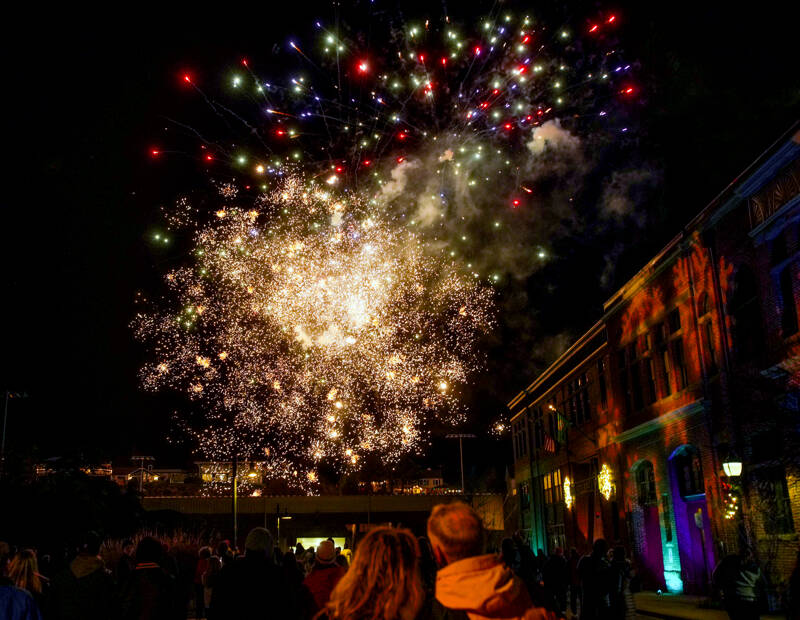 Spectators watch as fireworks explode over Memorial Field in downtown Port Townsend on Saturday night to herald in the new year. The fireworks, set to go off at 9 p.m. to coincide with the Times Square celebration in New York City, were the concluding event of First Night, an all-ages New Year’s Eve event put on by The Production Alliance, a non-profit in Port Townsend. Madison Street, site of city hall on the right, was blocked off so people could watch the display unhindered by traffic. (Steve Mullensky/for Peninsula Daily News)