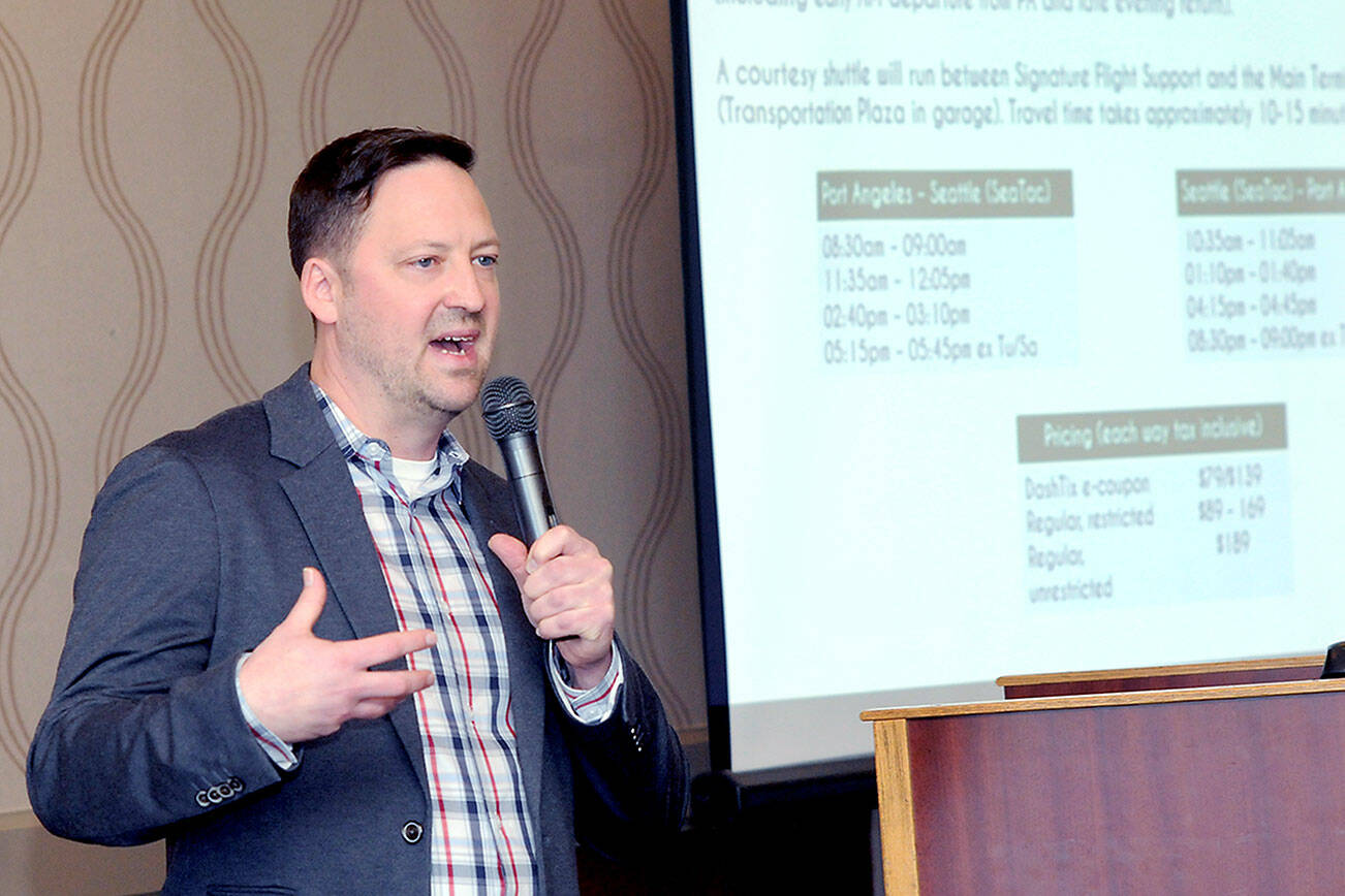 Clint Ostler, president of Dash Air Shuttle, provides an update on starting service during Wednesday’s Port Angeles Chamber of Commerce luncheon. (Keith Thorpe/Peninsula Daily News)