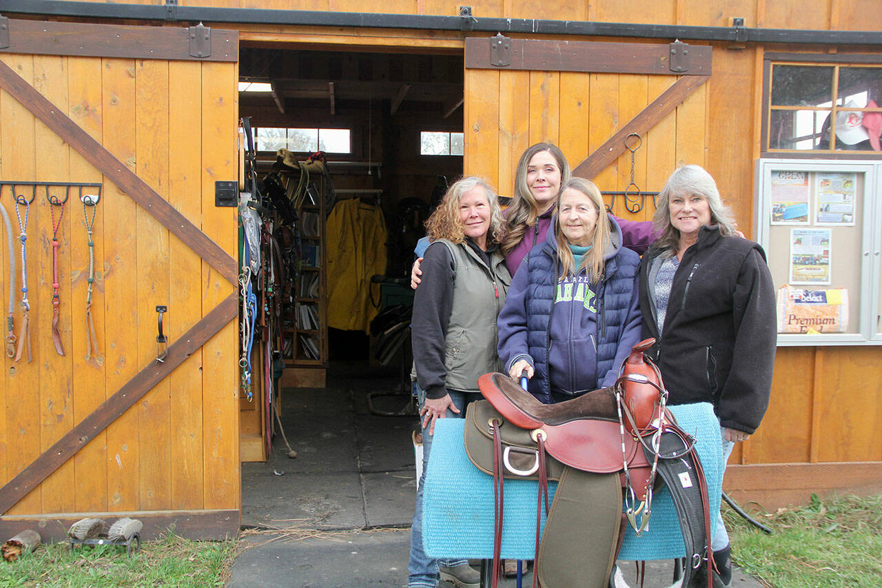 As OPEN enters its 16th year, the local horse rescue organization is reaching out to the public to ask for more donations, because for the first time, the 2022-year end finances showed a deficient. Co-founder Diane Royall, left, with horse trainer (and her daughter) Kate Tibbits, board member Glenda Cable and Co-founder Valerie Jackson stand in front of OPEN’s used tack shop at 251 Roupe Road in Sequim. Open by appointment only, all proceeds go to help horses in. For an appointment or other inquiries call and leave a message, including your name and phone number, at 360-207-1688. (KAREN GRIFFITHS/FOR PENINSULA DAILY NEWS)