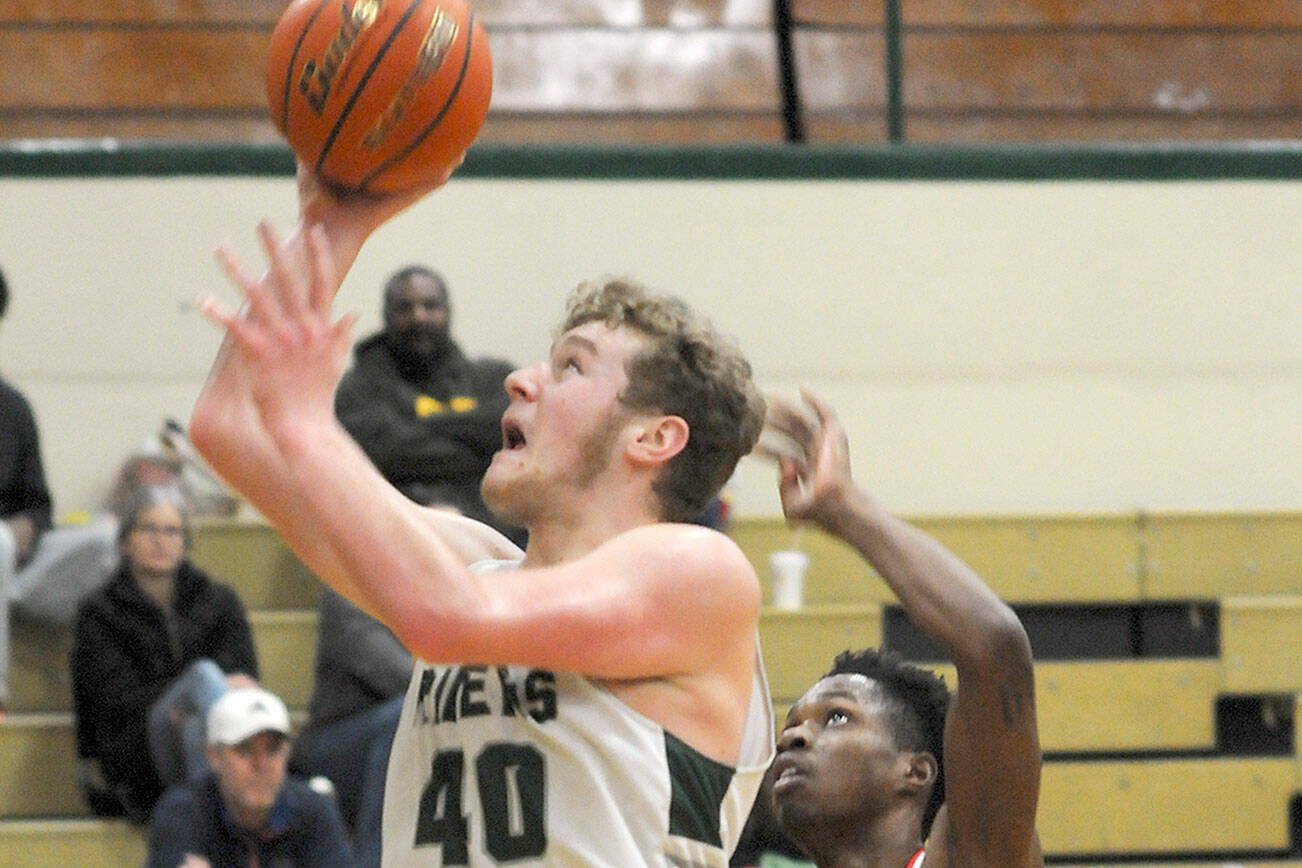 Keith Thorpe/Peninsula Daily News
Port Angeles' Isaiah Shamp, left, takes aim for the hoop as Renton's De'Rai Taylor tries to defend on Saturday at Port Angeles High School.