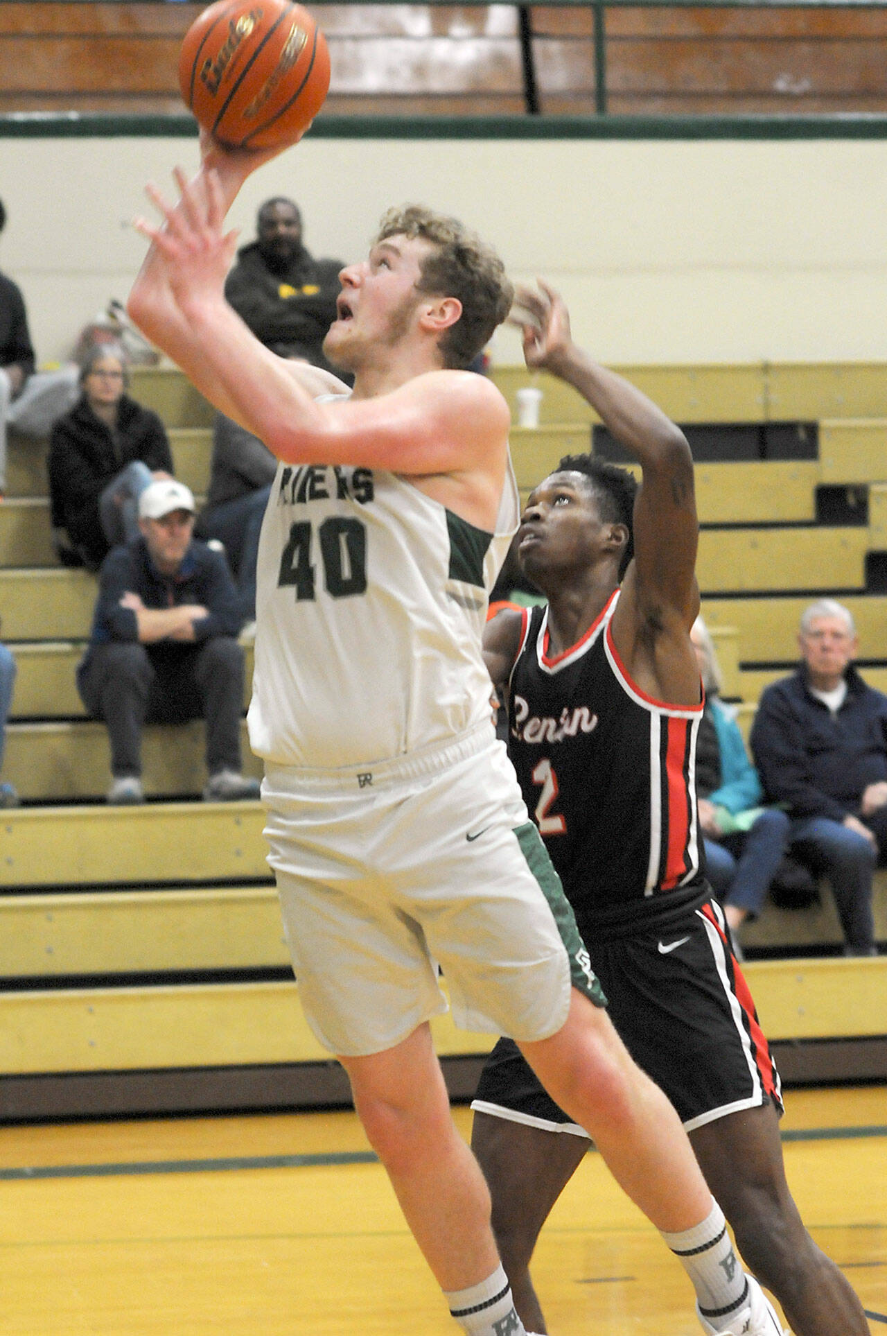 Keith Thorpe/Peninsula Daily News Port Angeles’ Isaiah Shamp, left, takes aim for the hoop as Renton’s De’Rai Taylor tries to defend on Saturday at Port Angeles High School.