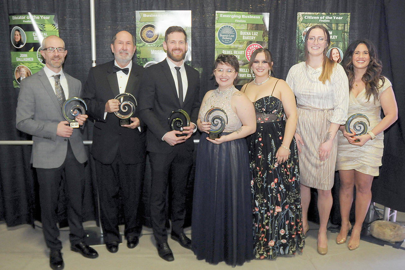 Port Angeles Community Award recipients gather after Saturday night’s fifth annual awards gala, including, from left, Joe DeScala, representing 4PA, organization of the year; Dr. Gerald Stephanz, citizen of the year; Tommy Harris, young leader of the year; Natalie Snow, Katelyn Sheldon and Andrea Dean, representing Welly’s Real Fruit Ice Cream, emerging business of the year; and Hayley Sharpe, owner of MOSS, business of the year. Not present was John Gallagher, educator of the year. The awards are produced by the Port Angeles Chamber of Commerce and sponsored by Sound Publishing. (Keith Thorpe/Peninsula Daily News)