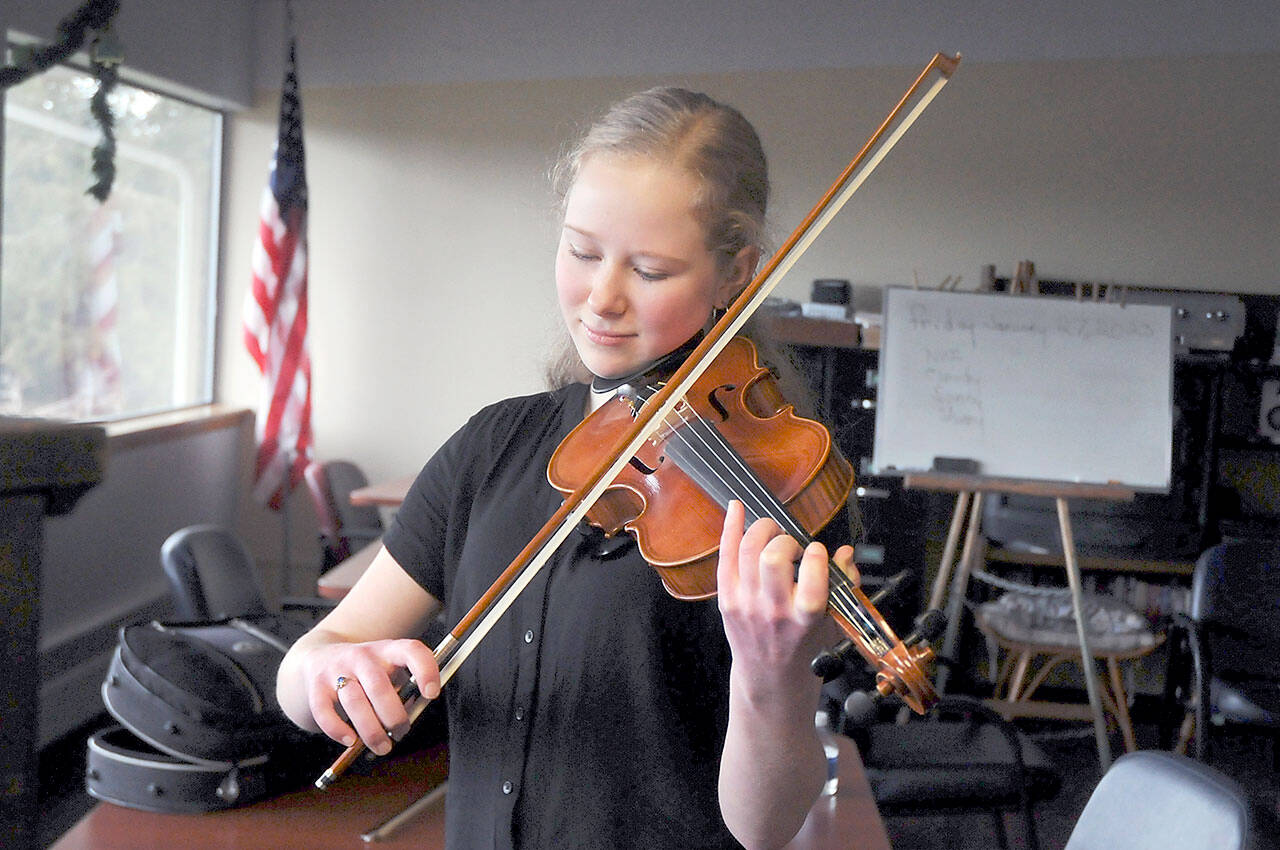 Anabel Moore, 17, of Port Townsend warms up on the violin prior to performing for the judges during Saturday’s 37th annual Nico Snel Young Artist Competition at Holy Trinity Lutheran Church in Port Angeles. Youth musicians from across the North Olympic Peninsula performed classical pieces for cash prizes in an event hosted by the Port Angeles Symphony Orchestra. (Keith Thorpe/Peninsula Daily News)