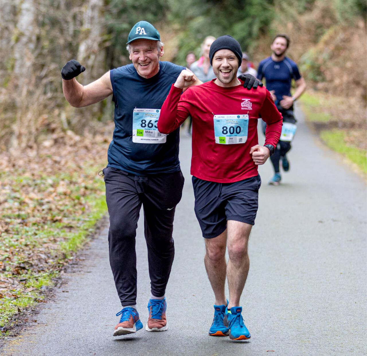 Mike Nolan (863) of Port Angeles and Jay Nolan (800) of Lynnwood run along the Olympic Discovery Trail in the Elwha Bridge Run 10K in 2022. (Run the Peninsula)