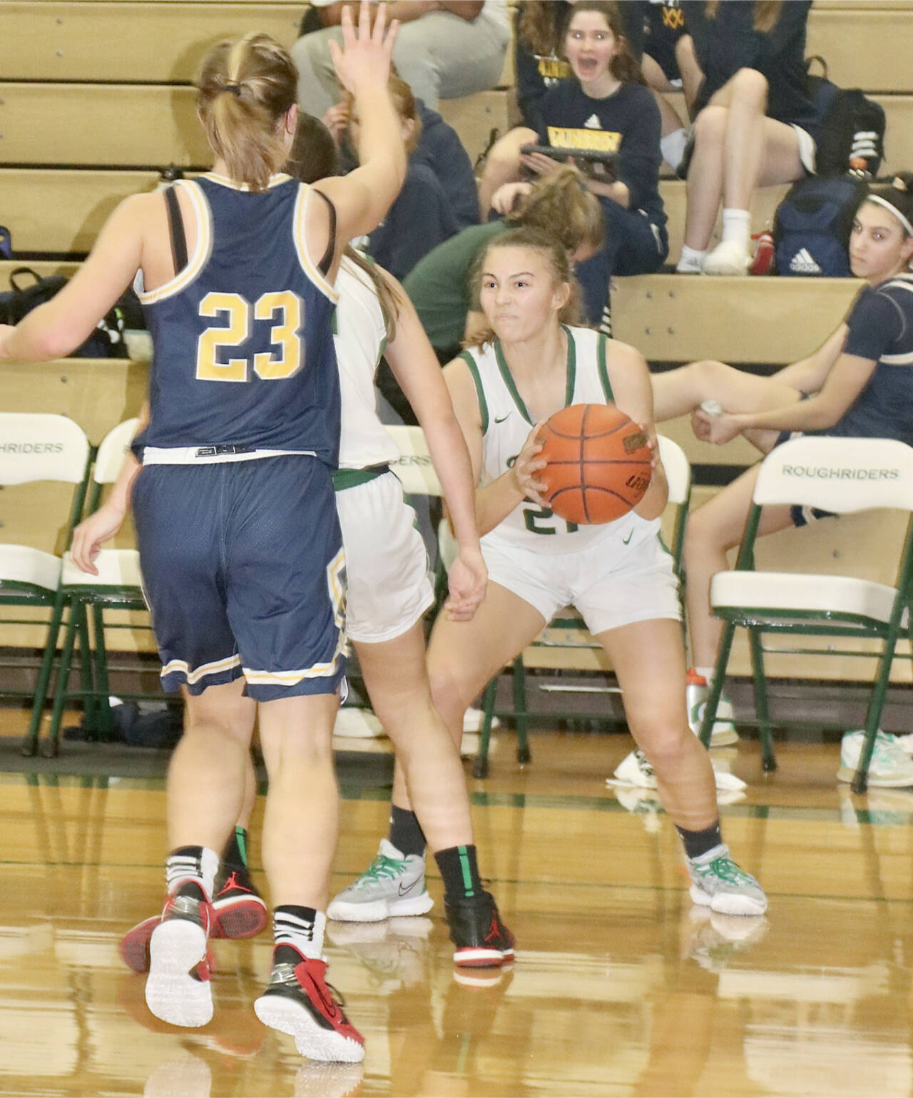 Port Angeles’ Kennedy Rognlien, gets around a pick set by a teammate against Bainbridge’s Sierra Berry (23) on Saturday in Port Angeles. (Dave Logan/for Peninsula Daily News)