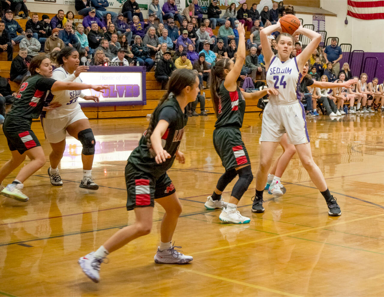 Sequim’s Dani Herman looks to pass out of the defense of Neah Bay’s Amber Swan, left, Allie Greene and Qwaapeys Greene on Tuesday in Sequim. Also in on the play is Sequim’s Jelissa Julmist. (Emily Matthiessen/Olympic Peninsula News Group)