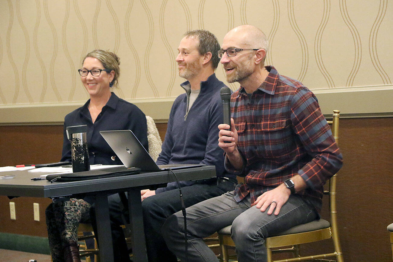 Ken Park/Peninsula Daily News
4P founder Joe DeScala, far right, speaks to a group of about 50 people during a town hall meeting, sitting with board members Justine Snook, center, and Jessica Irvine, left.