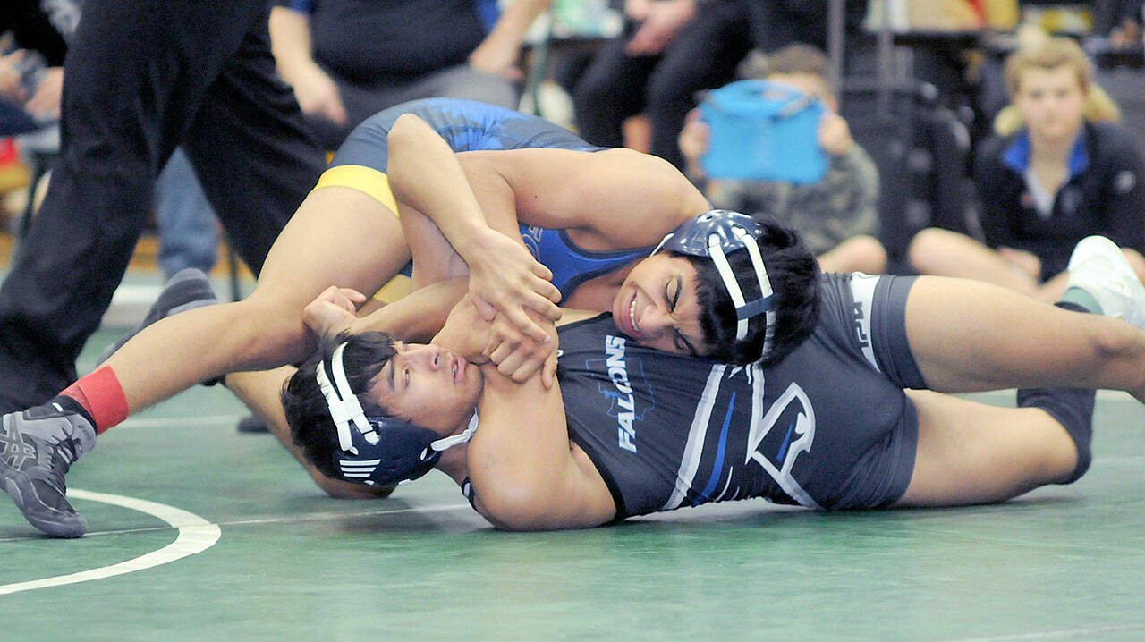 Bryan Lucas of Forks tries to pin Ravi Neumeyer of South Whidbey in the 120-pound class on Saturday at the Battle of the Ax in Port Angeles. (Keith Thorpe/Peninsula Daily News)