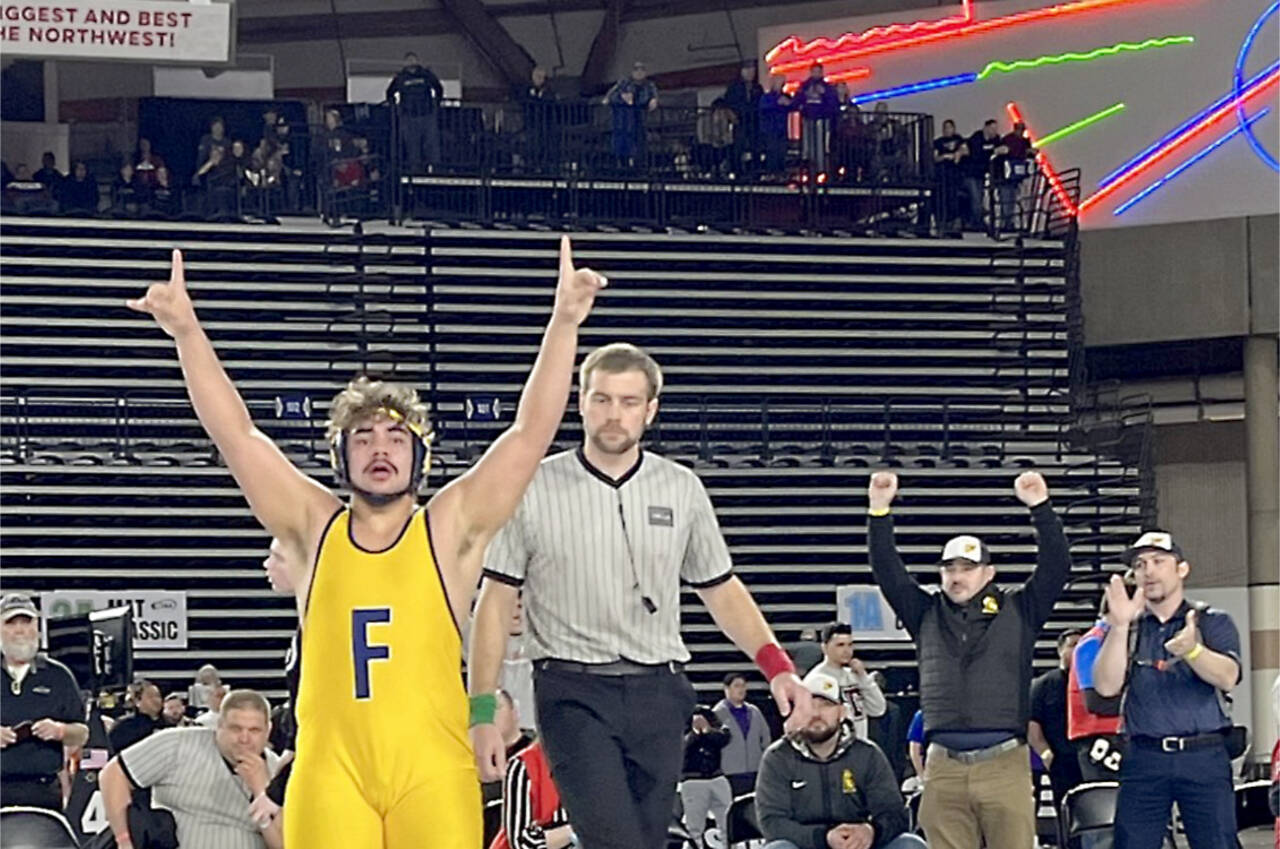 Forks' Sloan Tumaua celebrates after winning the 220-pound 1B/2B state championship at the Mat Classic late Saturday night. (WIAA photo)