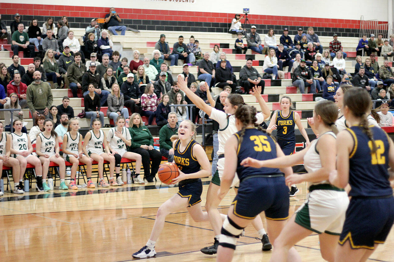 Forks’ Kadie Wood drives the lane during the Spartans’ Class 2B state regional round contest against Northwest Christian (Colbert) at Cheney High School on Friday. (Drew Lawson/The Lincoln County Record-Times)