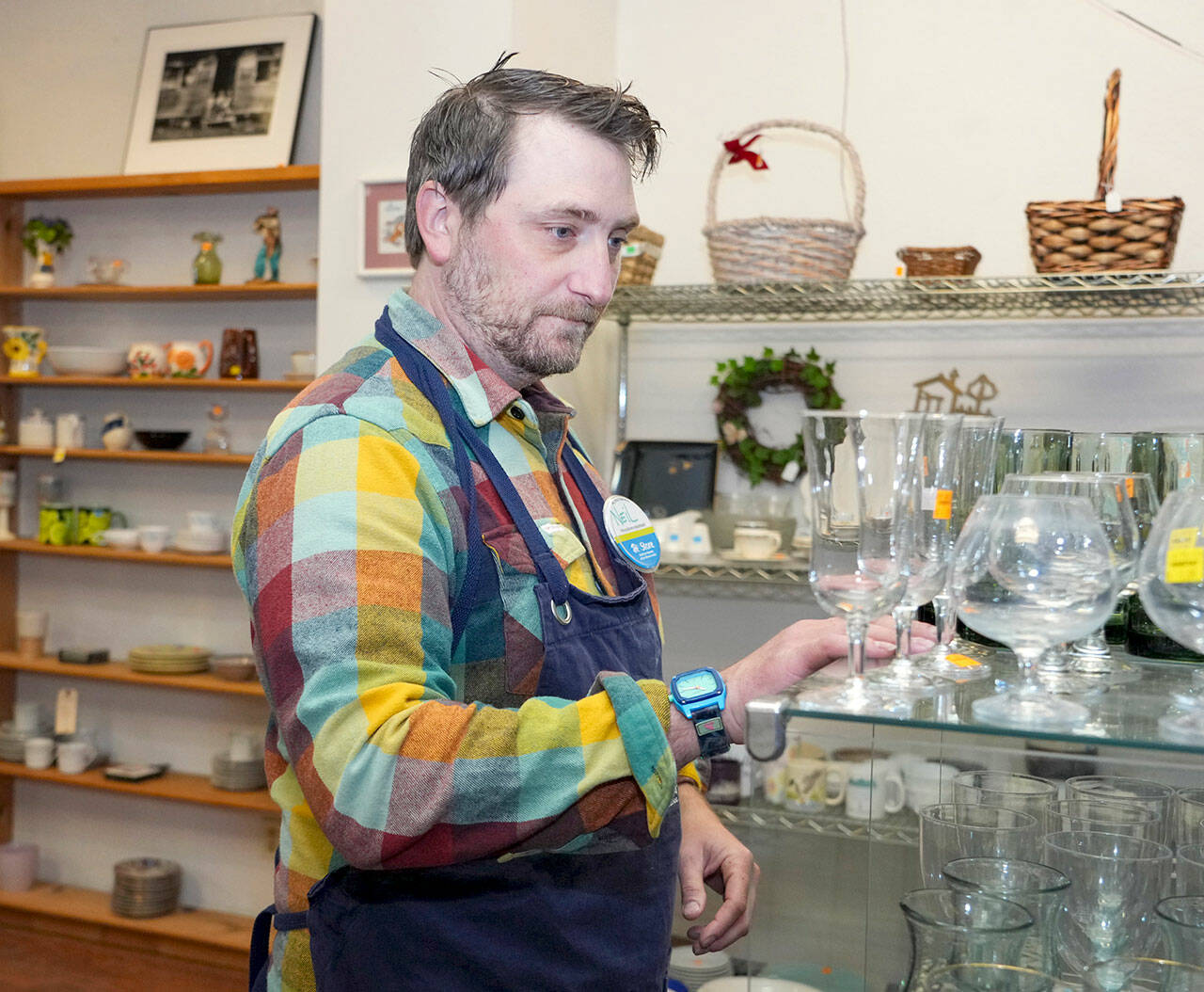 Neil Howe works Wednesday at the ReStore for Habitat for Humanity East Jefferson County in Port Townsend. (Steve Mullensky/for Peninsula Daily News)