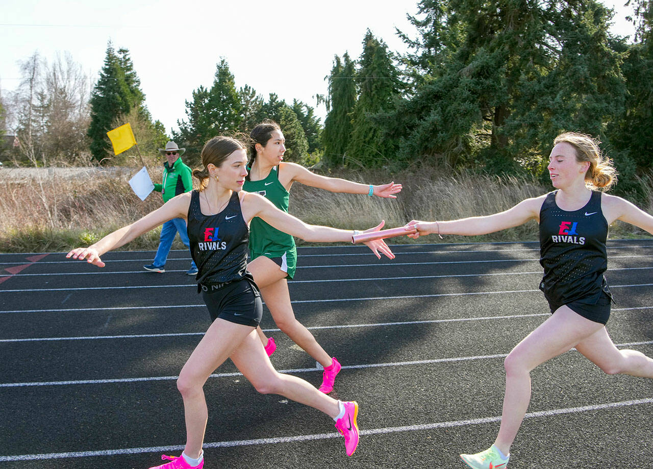 Steve Mullensky/for Peninsula Daily News Rivals’ Audry Matthes hands off to Kay Botkin in the first leg of the 1x400 meter relay during a track meet at Blue Heron Middle School on Thursday. The team, including Aliyah Yearian and Camryn Hines won the event
