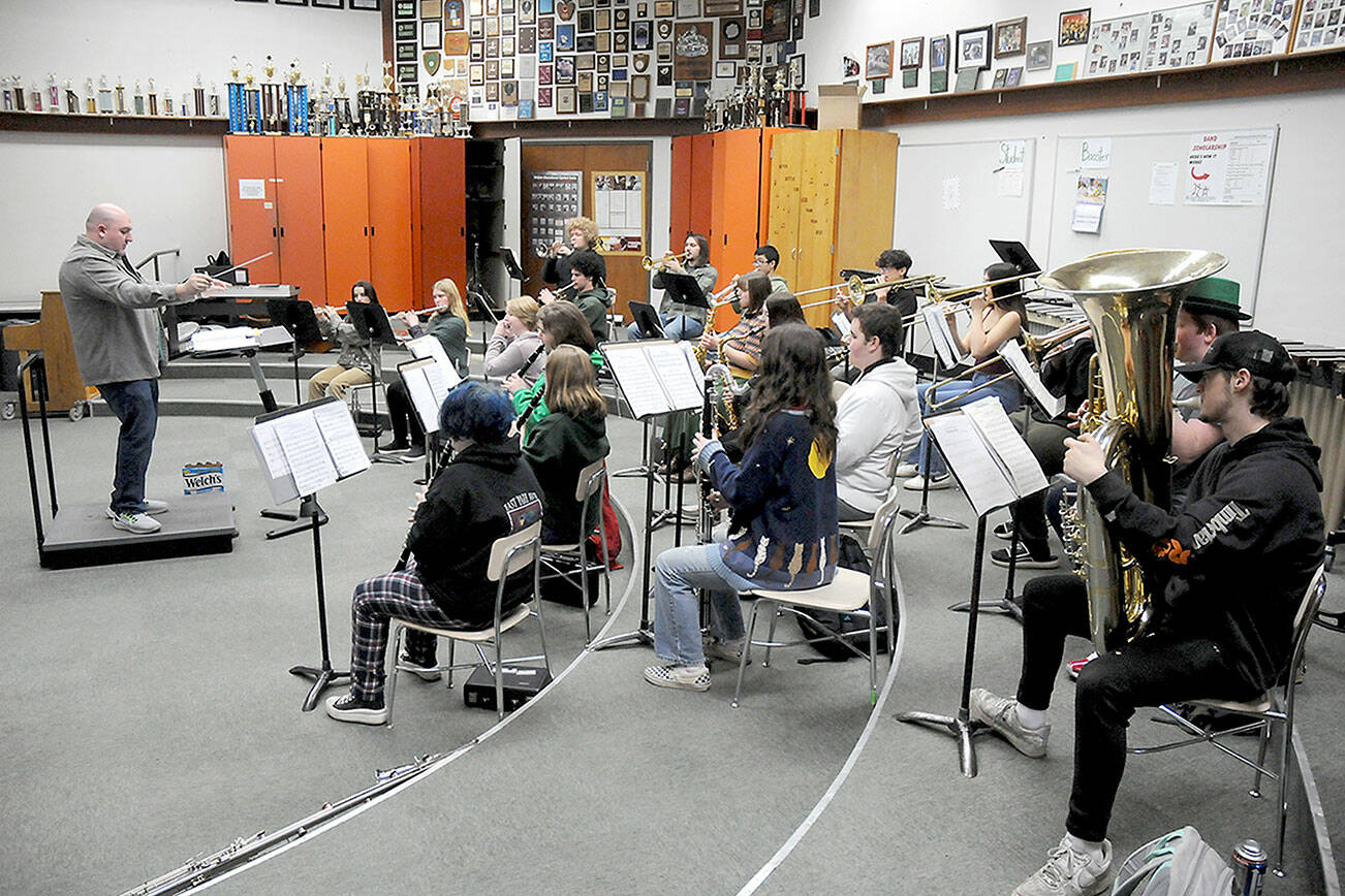 Members of the Port Angeles High School Band, under the direction of Jarrett Hansen, left, practice on Friday in preparation for the group’s upcoming appearance at Carnegie Hall in New York. (Keith Thorpe/Peninsula Daily News)