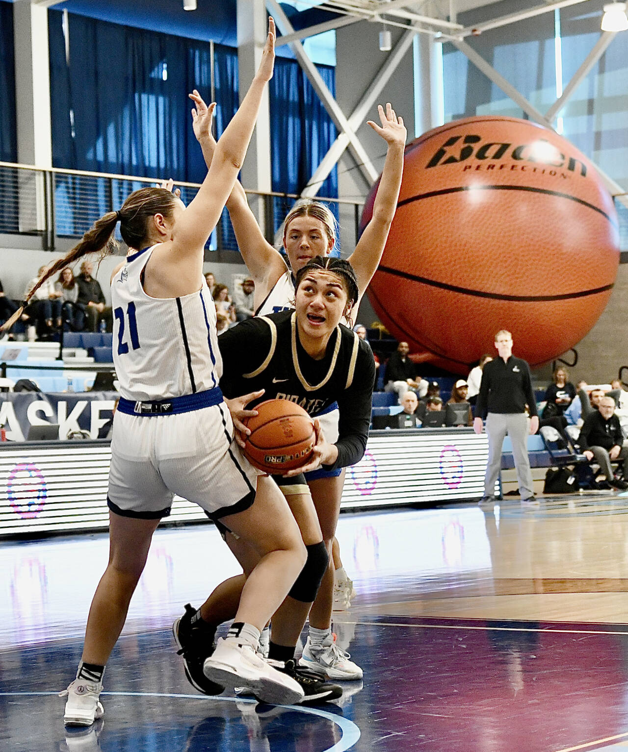 Peninsula’s Itaua Tuisaula battles through a Lane double team during the NWAC semifinals held Saturday in Pasco. Tuisaula had 14 points, 15 rebounds and four blocks before leaving the game with an ankle injury. (Jay Cline/Peninsula College)
