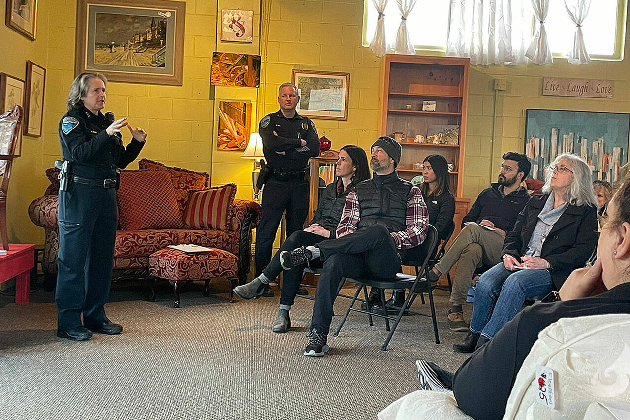 Sequim Police Chief Sheri Crain talks with a crowd at a Sequim Business Merchants meeting. She encouraged people to call police if they see something suspicious. (Matthew Nash/Olympic Peninsula News Group)