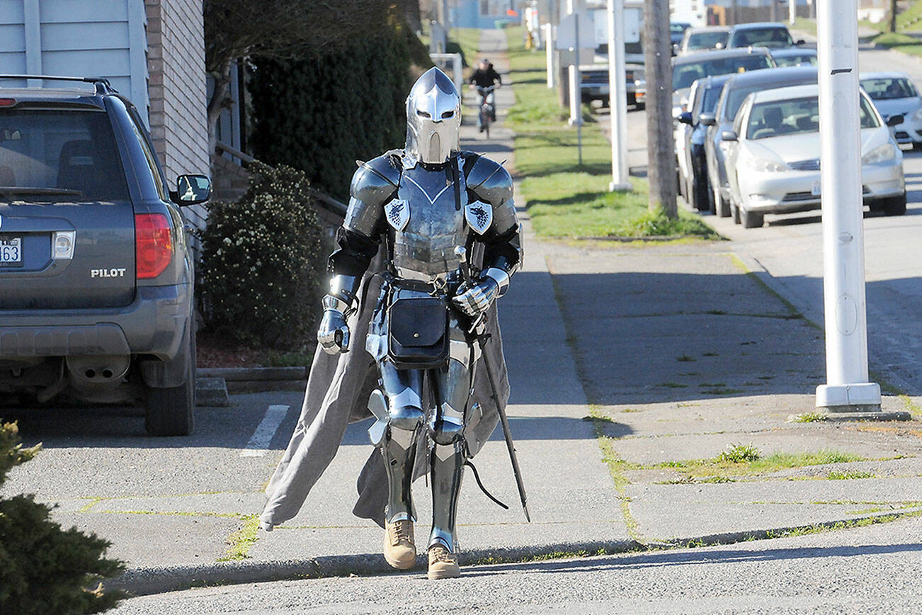 KEITH THORPE/PENINSULA DAILY NEWS
Cavin Vernwald of Port Angeles walks down Lincoln Street in a suit of armor on Wednesday in Port Angeles. Vernwald said  the suit was a hobby and decided that he would run errands while wearing it.