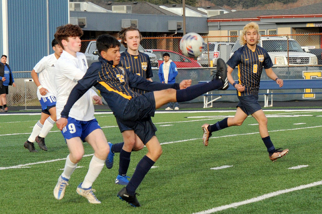 Spartan Jorge Diaz kicks back over his head towards the Forks goal while teammates Brody Owen and DeAnthony Davila (8) look on. Also in the action are Elma’s Matthew Wood (9) and Theo Flores (10). Photo by Lonnie Archibald.