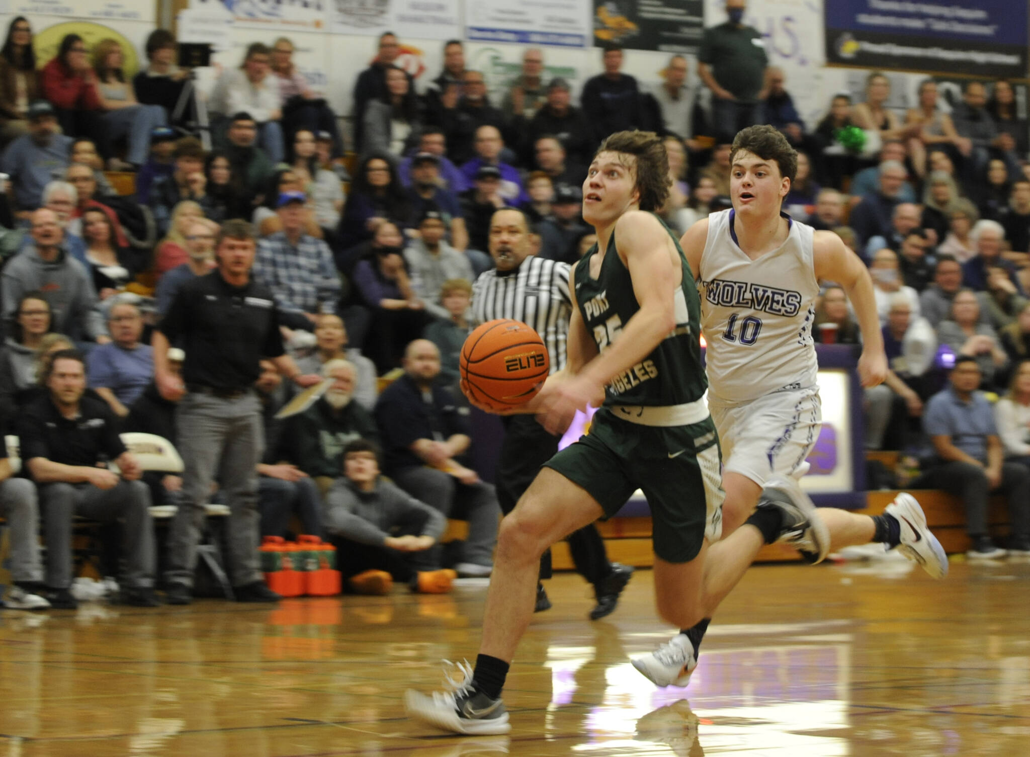 Port Angeles’ Parker Nickerson eyes the rim on a breakaway while chased by Sequim’s Keenan Greene. Nickerson is the 2022-23 All-Peninsula Boys Basketball MVP. (Michael Dashiell/Olympic Peninsula News Group)