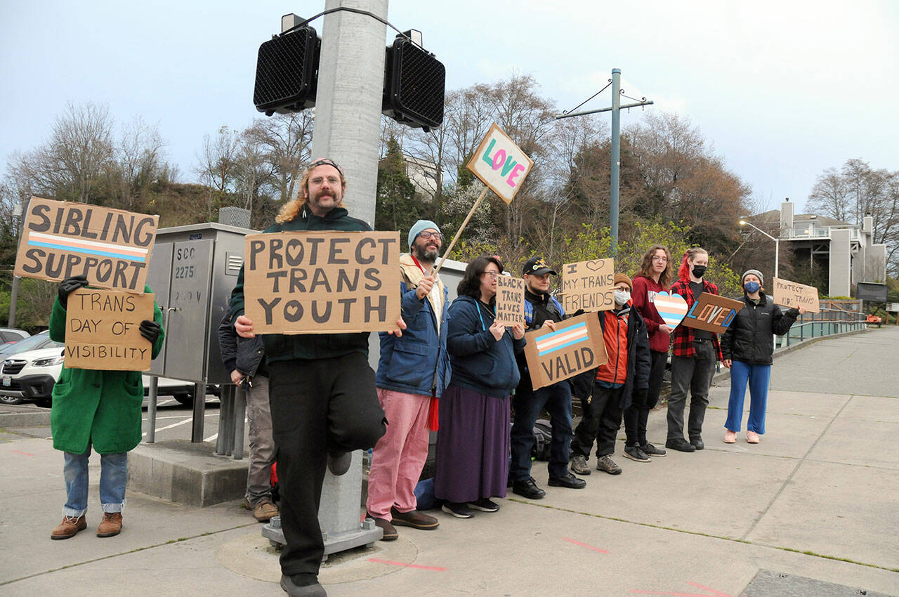 People gather at First and Lincoln streets in Port Angeles on Friday in support of transgender rights. The group was celebrating the International Transgender Day of Visibility, an annual event celebrating transgender people and raising awareness of discrimination they can face. (Keith Thorpe/Peninsula Daily News)