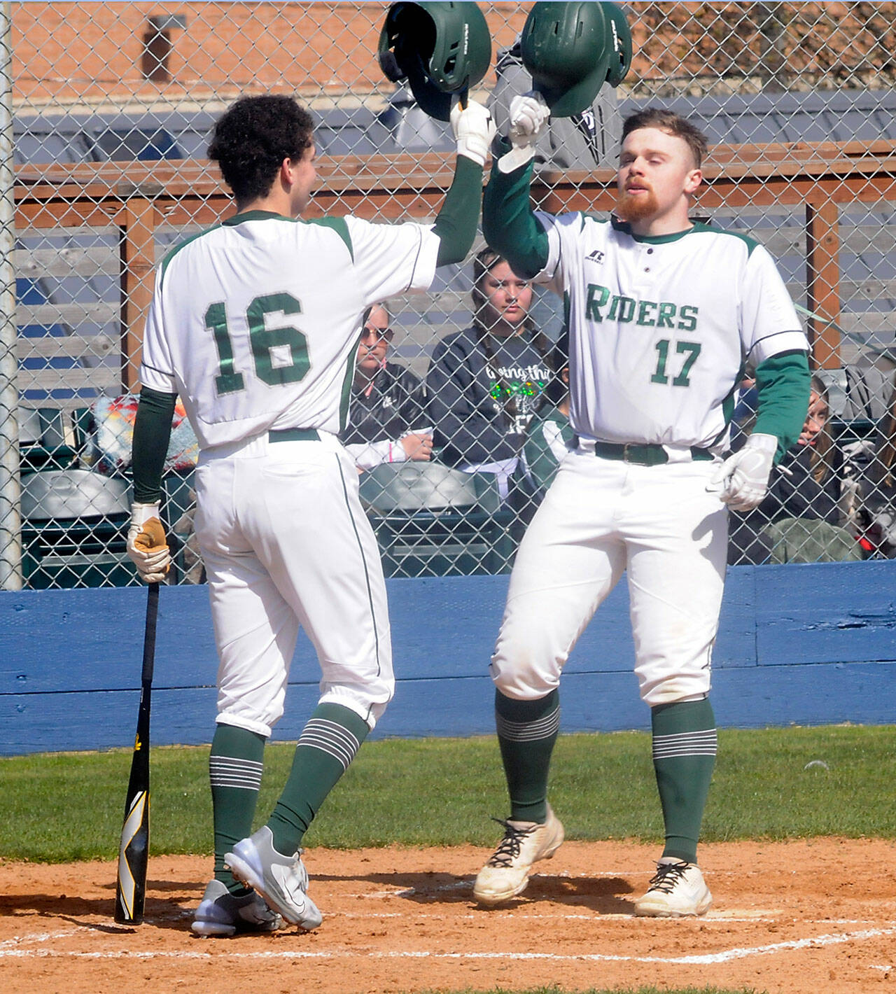 Port Angeles’ Ezra Townsend, right, is greeted at home plate by teammate Kaleb Mullen after Townsend batted a solo homer in the third inning against South Whidbey on Tuesday in Port Angeles. (Keith Thorpe/Peninsula Daily News)