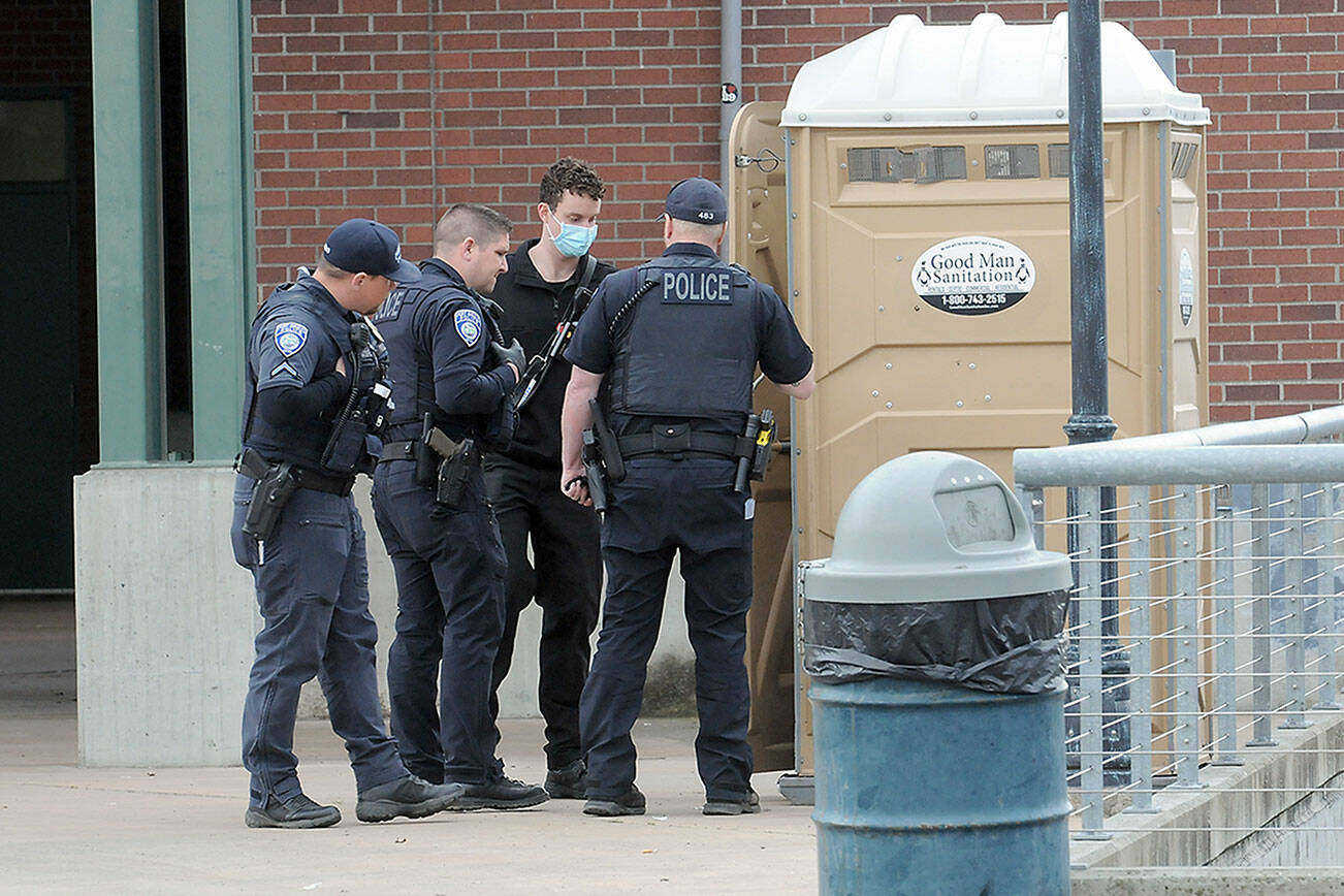 KEITH THORPE/PENINSULA DAILY NEWS
Port Angeles police and medical workers investigate the scene of a body found at The Gateway in downtown Port Angeles.