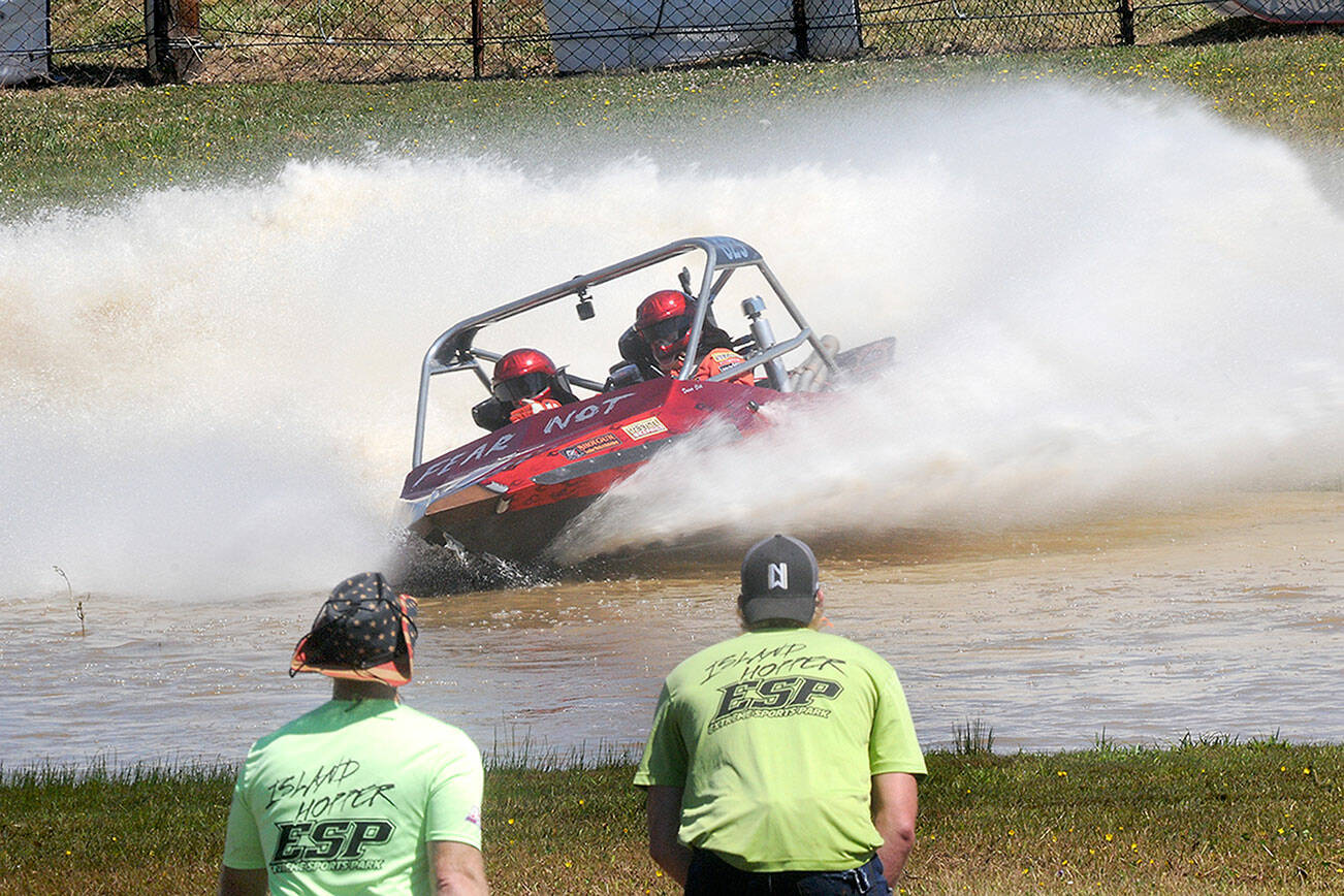 Keith Thorpe/Peninsula Daily News
The Fear Not sprint boat driven by Clint Birch and navigated by Terri Lovell speeds through the Extreme Sports Park course as a pair of "island hopper" safety crew members watch the action on Saturday in Port Angeles.