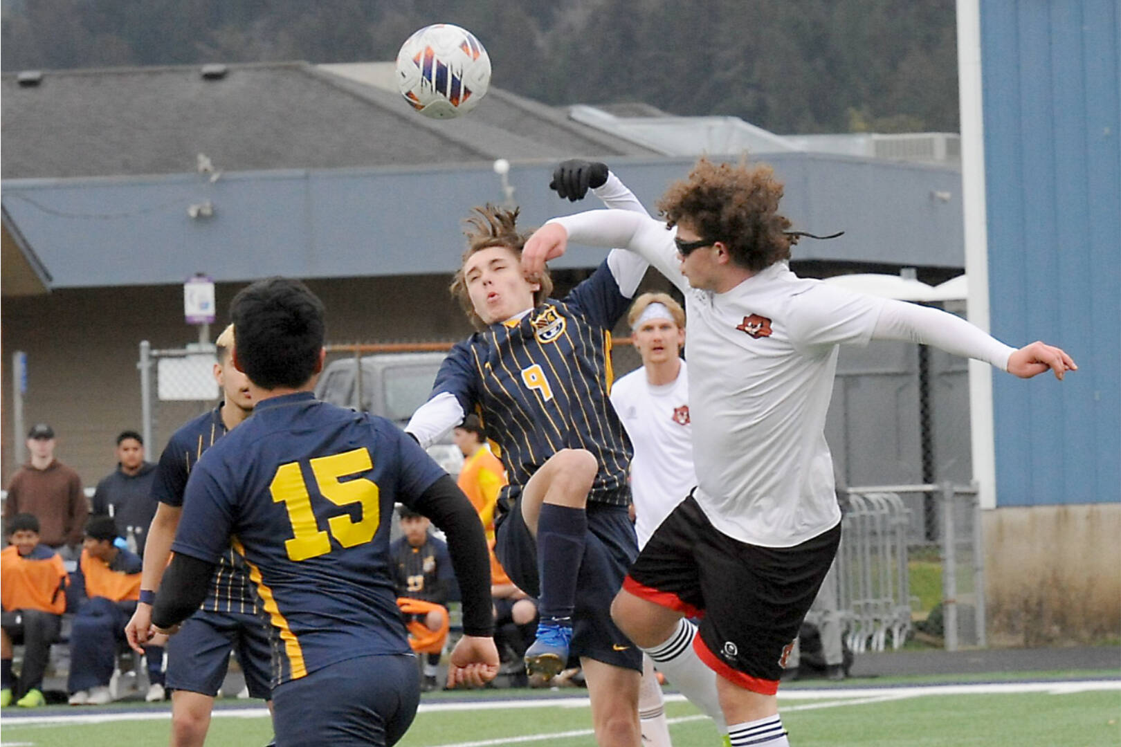 Forks' Brody Owen (9) challenges Tenino's Tyle Minerich for ball control Monday evening in Forks. Also in the action is Spartan Kevin Udave-Ramos (15). Tenino won the match 5-3. (Lonnie Archibald/for Peninsula Daily News.)