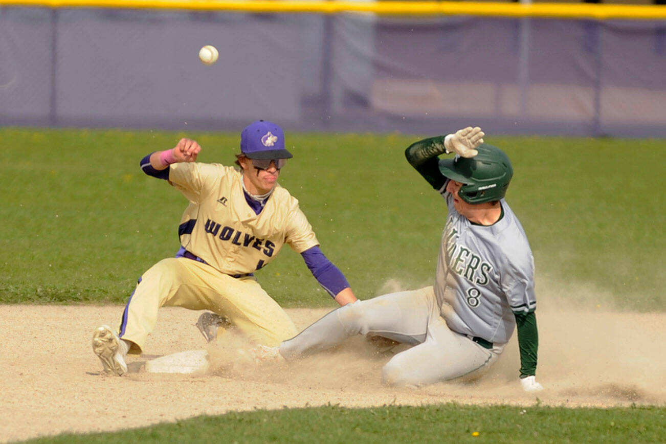Michael Dashiell/Olympic Peninsula News Group
Sequim's Bryan Laboy, left, looks to put the tag on Port Angeles' Colton Romero in the third inning of an Olympic League match-up on April 13. The Roughriders scored five innings en route to a 12-2 win in Sequim.