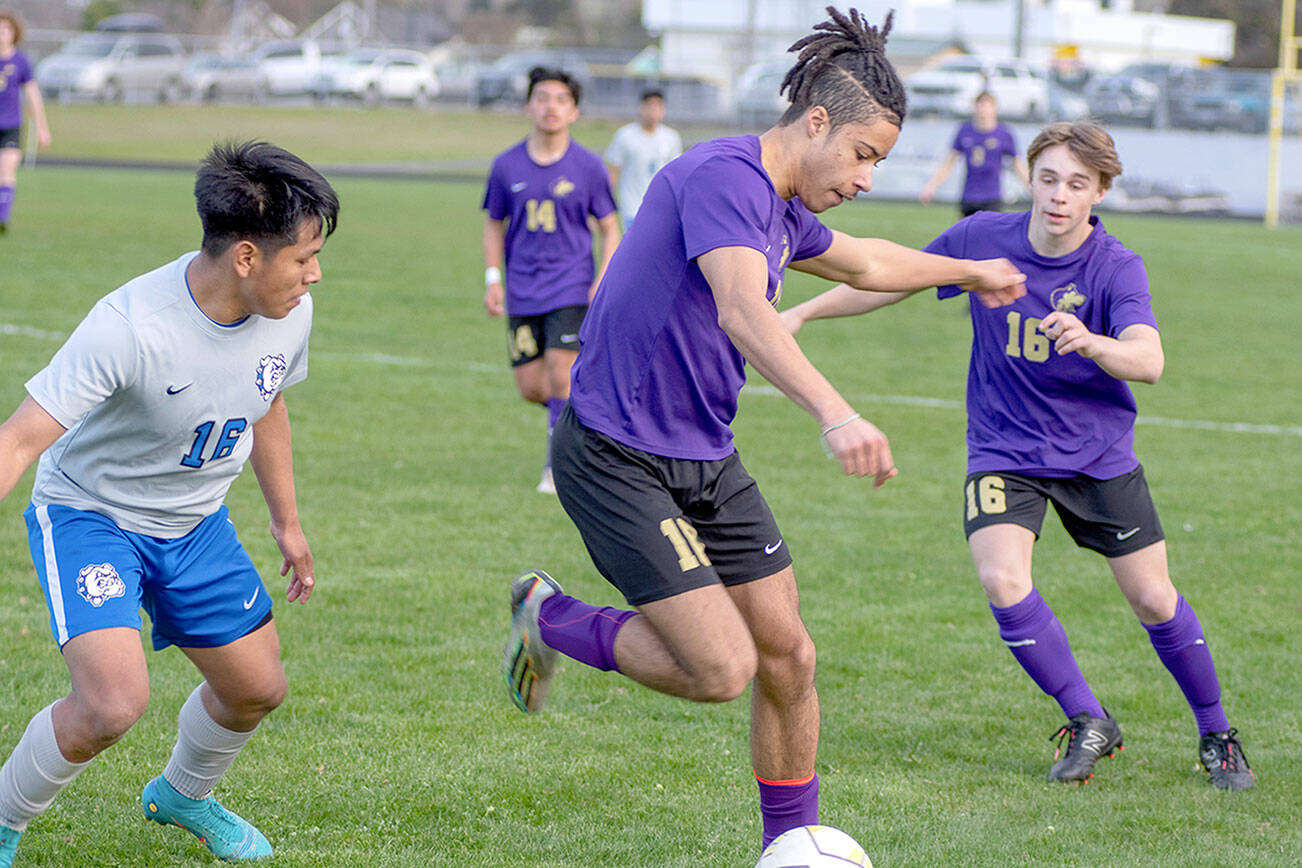 Emily Matthiessen/Olympic Peninsula News Group
Sequim's Mekhi Ashby possesses the ball while teammate James Mason, right, looks on during the Wolves' 2-1 win over North Mason on Thursday.