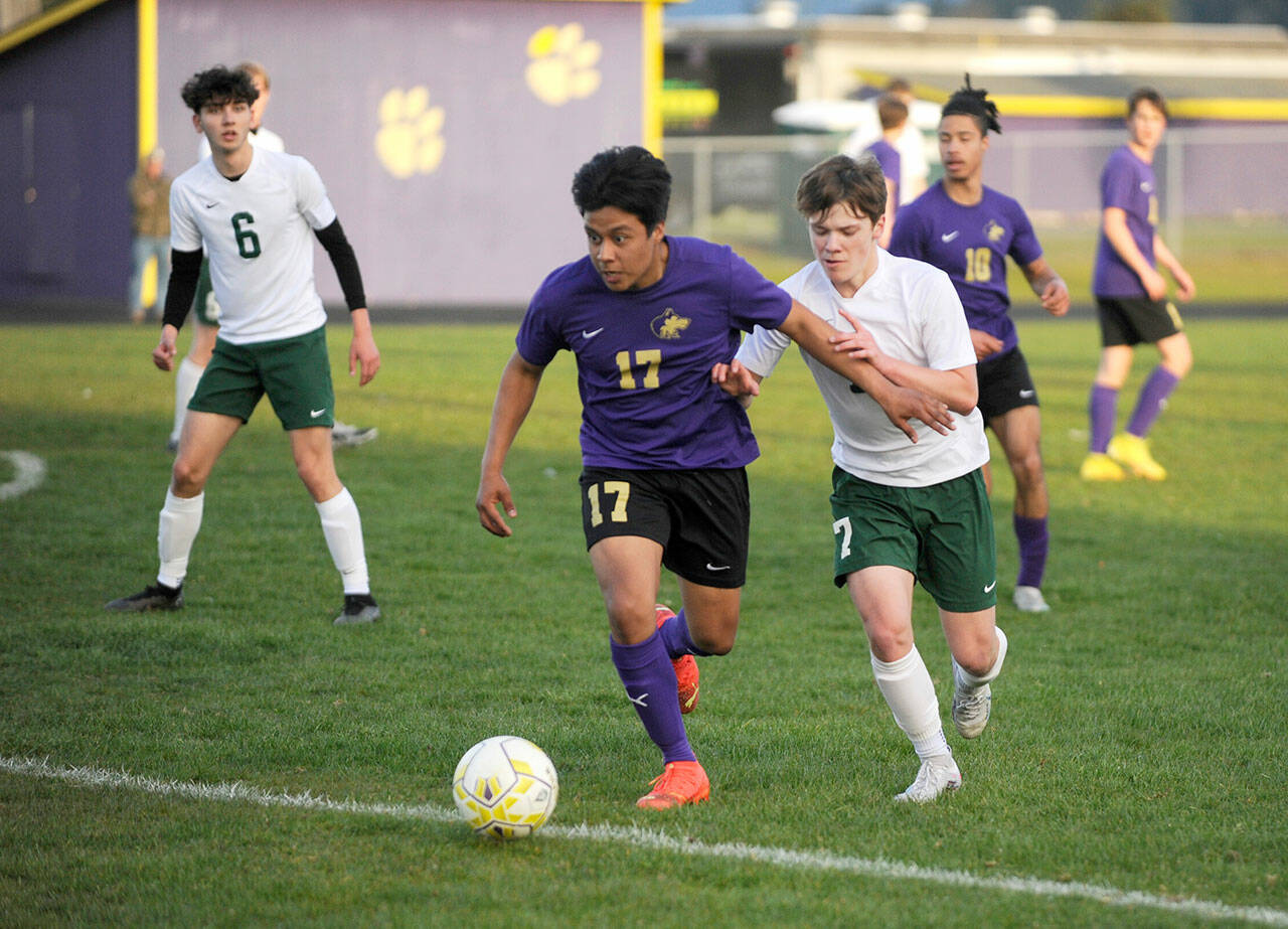 Sequim’s Abe Torres, left, vies with Port Angeles’ Kaleb Gagnon during the Wolves’ 1-0 win over the Roughriders on Tuesday. (Michael Dashiell/Olympic Peninsula News Group)