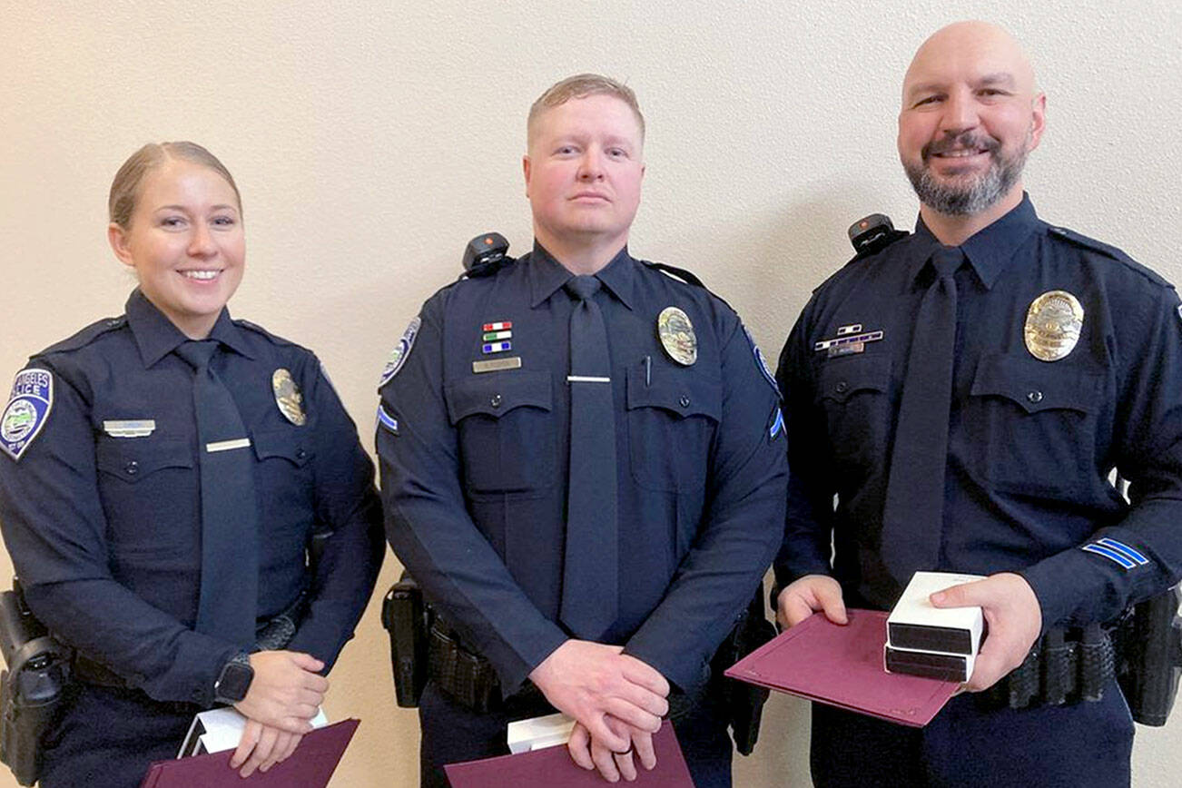 Officer Lilliana Emery, Officer Kyle Cooper and Cpl. Jeff Ordona, from left. were recognized by the Port Angeles City Council for their actions in saving a man in a burning car. The three received Life Saving Medals and Meritorious Service Medals.