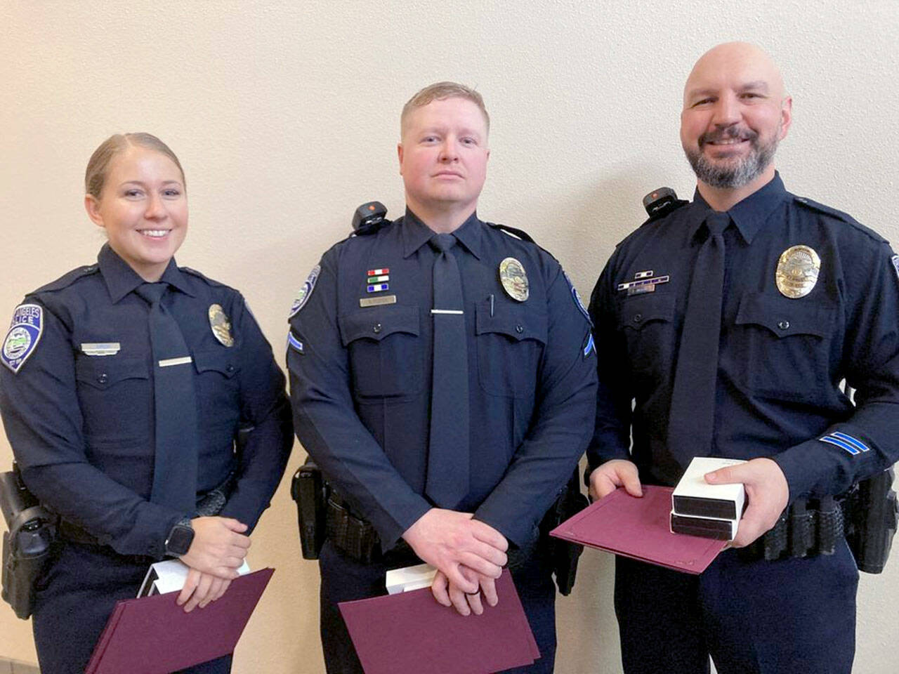 Officer Lilliana Emery, Officer Kyle Cooper and Cpl. Jeff Ordona, from left. were recognized by the Port Angeles City Council for their actions in saving a man in a burning car. The three received Life Saving Medals and Meritorious Service Medals.