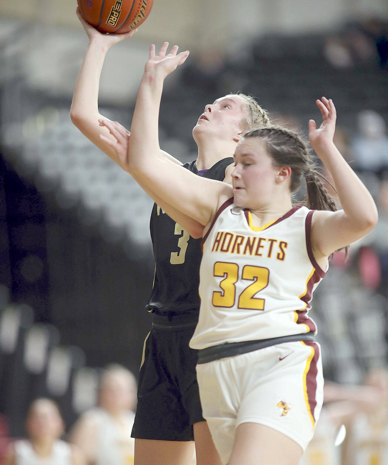 Sequim’s Jolene Vaara puts up a layup while fending off the defense of White River’s Dakota Sprouse during their Class 2A state quarterfinal at the Yakima SunDome. (David Willoughby/for Peninsula Daily News)