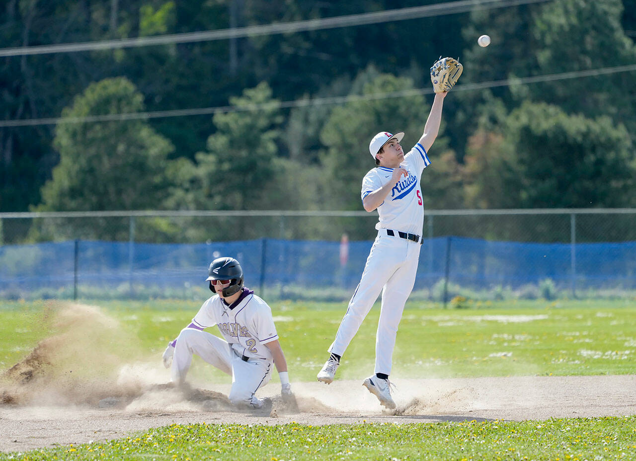 Sequim’s Zeke Schmadeke successfully steals second before the ball gets to Rivals’ second baseman Rylan Dunn during a game played in Chimacum on Tuesday. (Steve Mullensky/for Peninsula Daily News)
