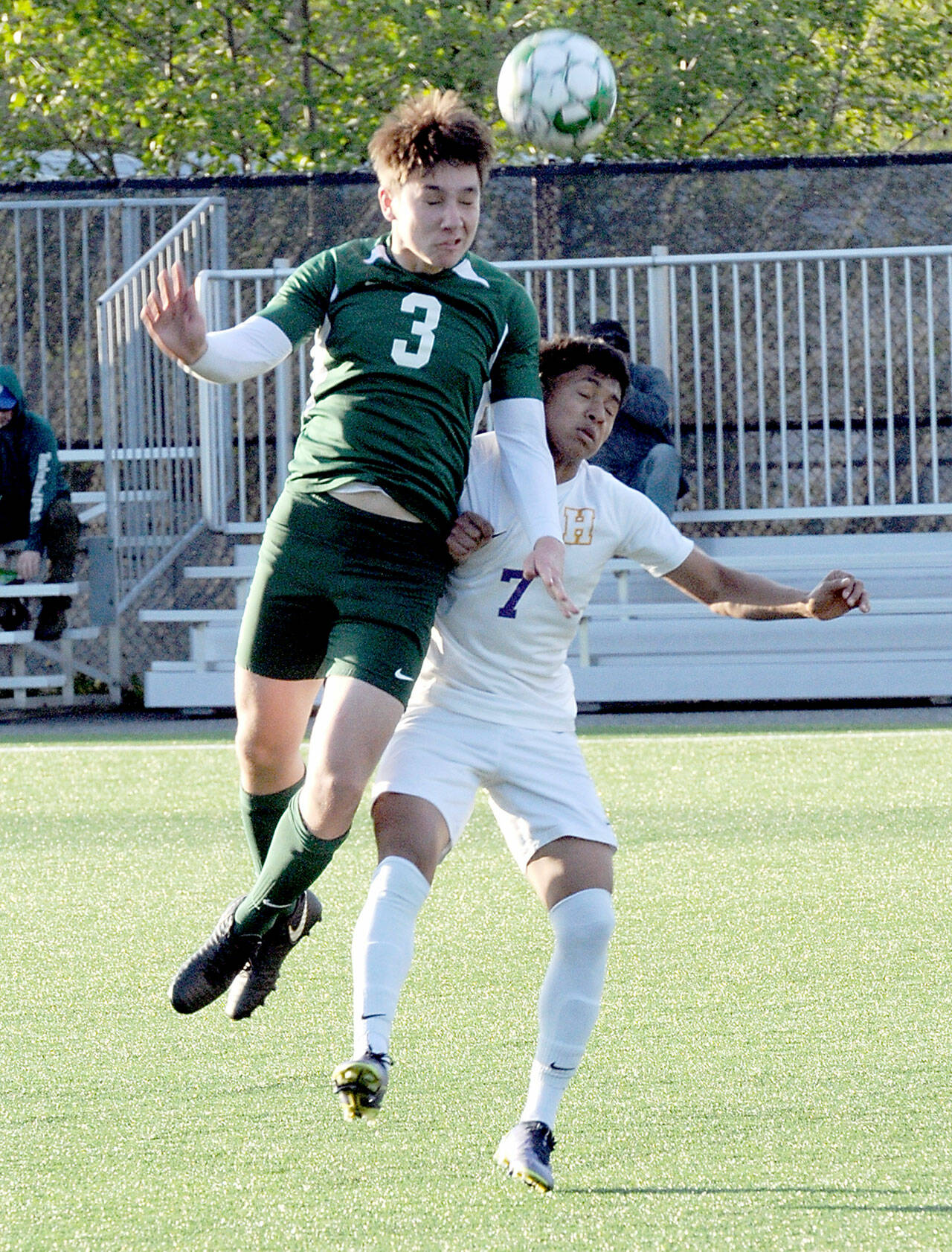 Port Angeles’ Landon Close, left, goes up and over Highline’s Yonatan Garcia-Arevalo on Tuesday in Port Angeles. (Keith Thorpe/Peninsula Daily News)