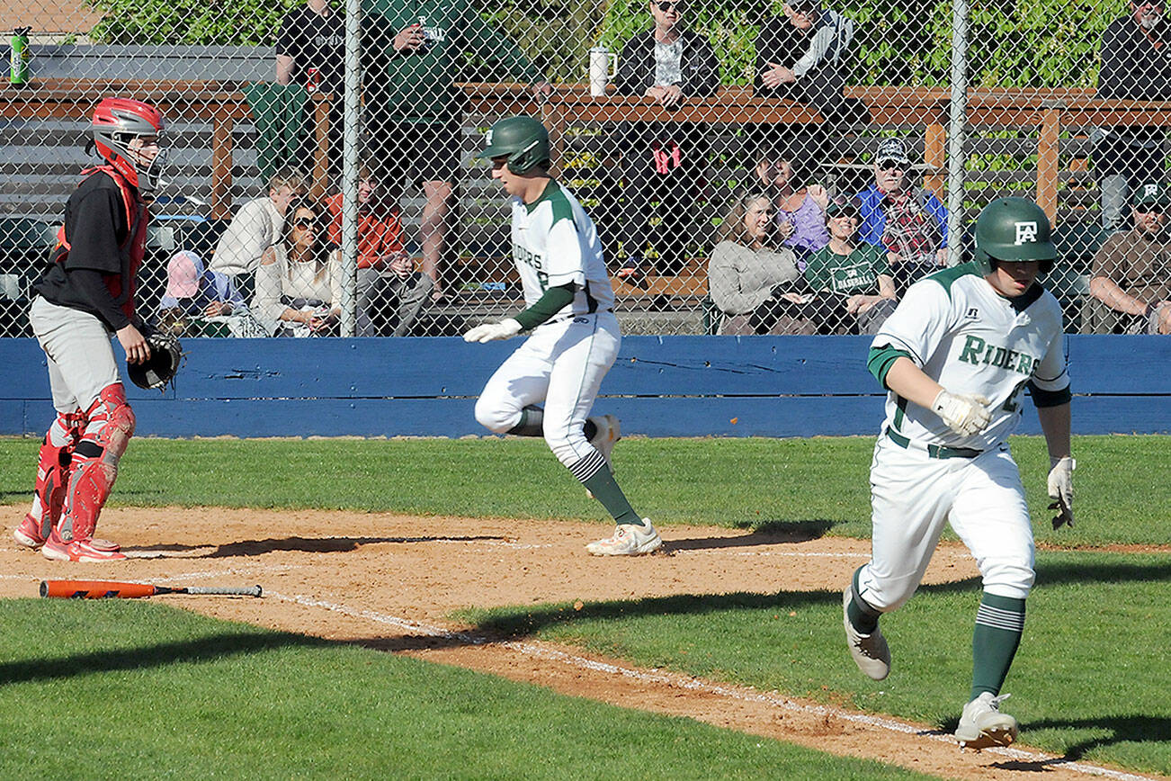 KEITH THORPE/PENINSULA DAILY NEWS
Port Angeles' Colton Romero, center, reaches the plate thanks to a sacrifice bunt by teammate Jordan Shumway, right, as Franklin Pierce catcher Trey Smith looks on helplessly in the second inning of Wednesday's playoff game at Port Angeles Civic Field.