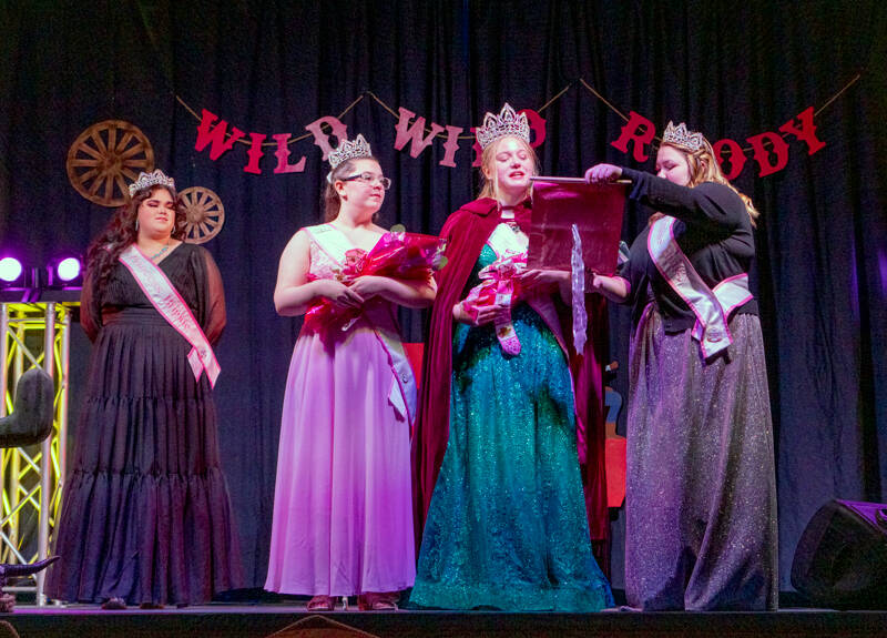 Newly crowned 2023 Rhody Festival Queen Melody Douglas performs her first official act by declaring the start of the Rhododendron Festival during a coronation at the Jefferson County Fairgrounds in March. Holding the proclamation is 2022 Princess Hailey Hirschel. Looking on are 2022 princess Bridgette Palmer, left, and 2023 princess Paige Covia. (Steve Mullensky/for Peninsula Daily News)