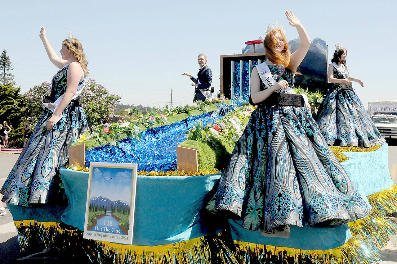Sequim Irrigation Festival royalty, from left, Princess Paige “Skylar” Krzyworz, Prince Fred Cameron, Princess Anne Marie Barni and Queen Pepper Reymond preside over the festival from their float in Saturday’s Grand Parade. (Keith Thorpe/Peninsula Daily News)
