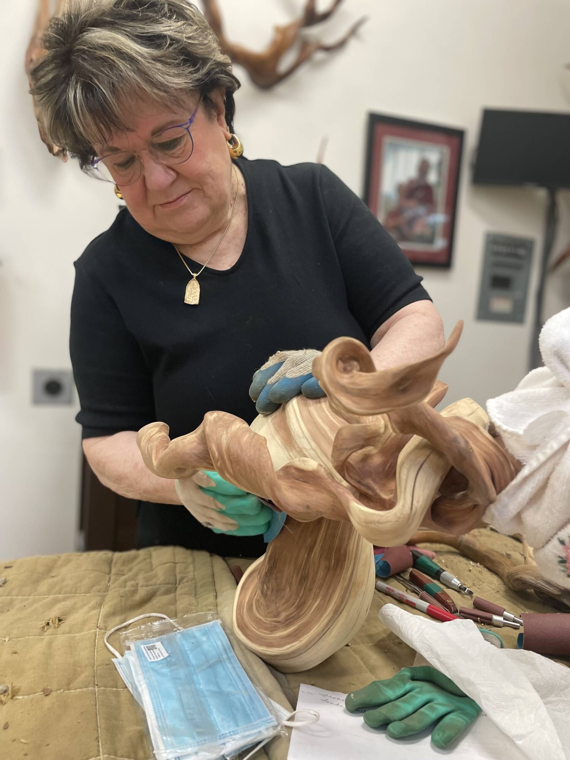 Driftwood art instructor Tuttie Peetz works on a driftwood art piece at her home studio for Olympic Driftwood Sculptors’ next show Saturday and Sunday at the Dungeness River Nature Center. She said she’s put in more than 1,000 hours into shaping the twisted juniper wood from Montana. (Matthew Nash/Olympic Peninsula News Group)
