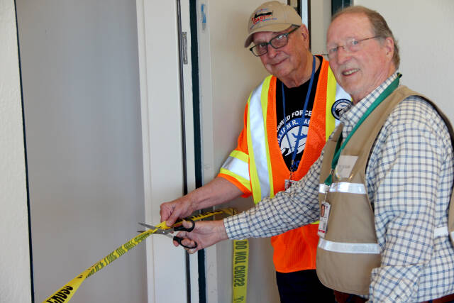 Alan Barnard, chair of Clallam County Disaster Airlift Response Team (DART) right, and David Woodcock, DART vice chair, cut the ribbon for the opening of the new DART Operations Center at Fairchild International Airport. (CLALLAM COUNTY DISASTER AIRLIFT RESPONSE TEAM )