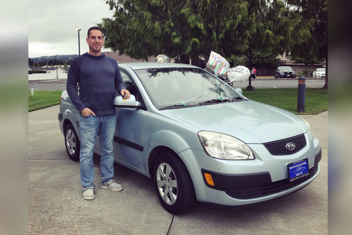 Owner Michael Rocha with a previous year’s prize vehicle given away by Rocha Family Auto Sales.