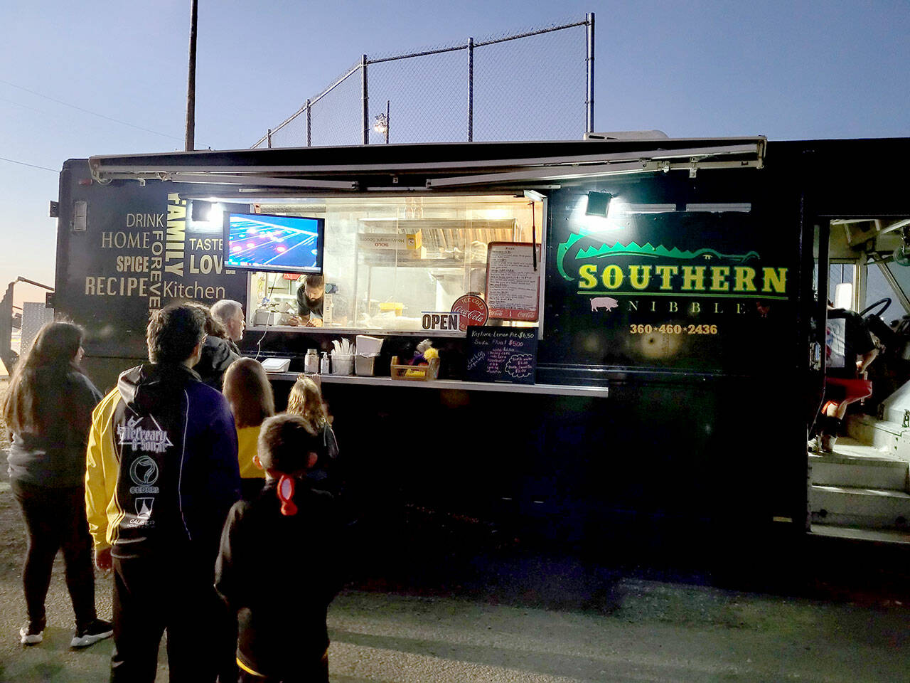 Caleb Messinger and staff with the Southern Nibble food truck serve customers at a Sequim High School soccer game in September 2022. (Michael Dashiell/Olympic Peninsula News Group)