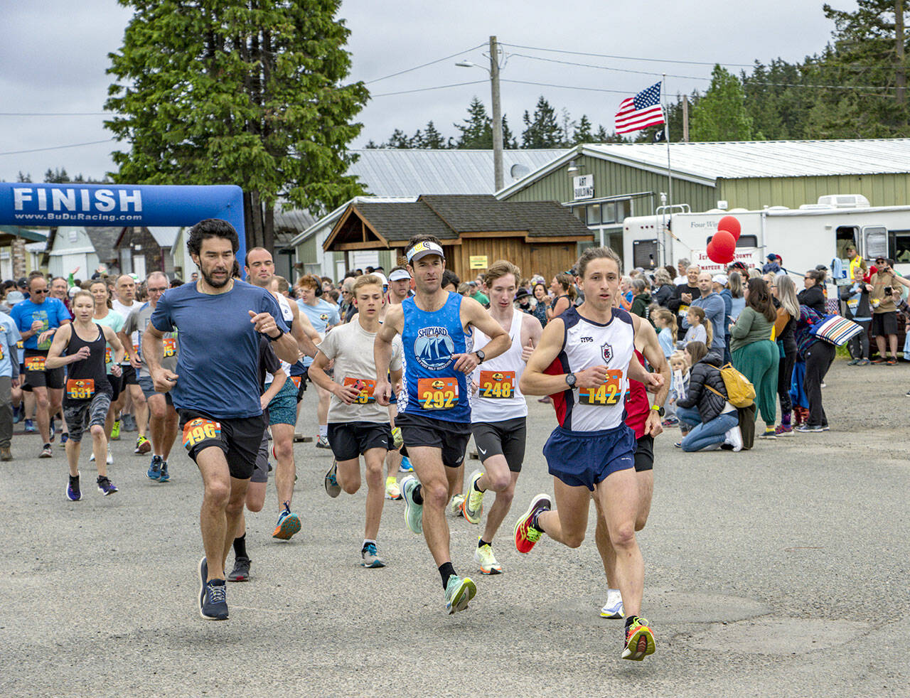 Port Townsend’s Seamus Fraser (142) is a step ahead of the rest of the nearly 1,000 competitors in the 2023 Rhody Run on Sunday at the Jefferson County Fairgrounds. Fraser had flown in from classes in Ecuador the night before in order to defend his victory from last year. Fraser won the 10K event with a time of 35 minutes, 24 seconds. (Steve Mullensky/for Peninsula Daily News)