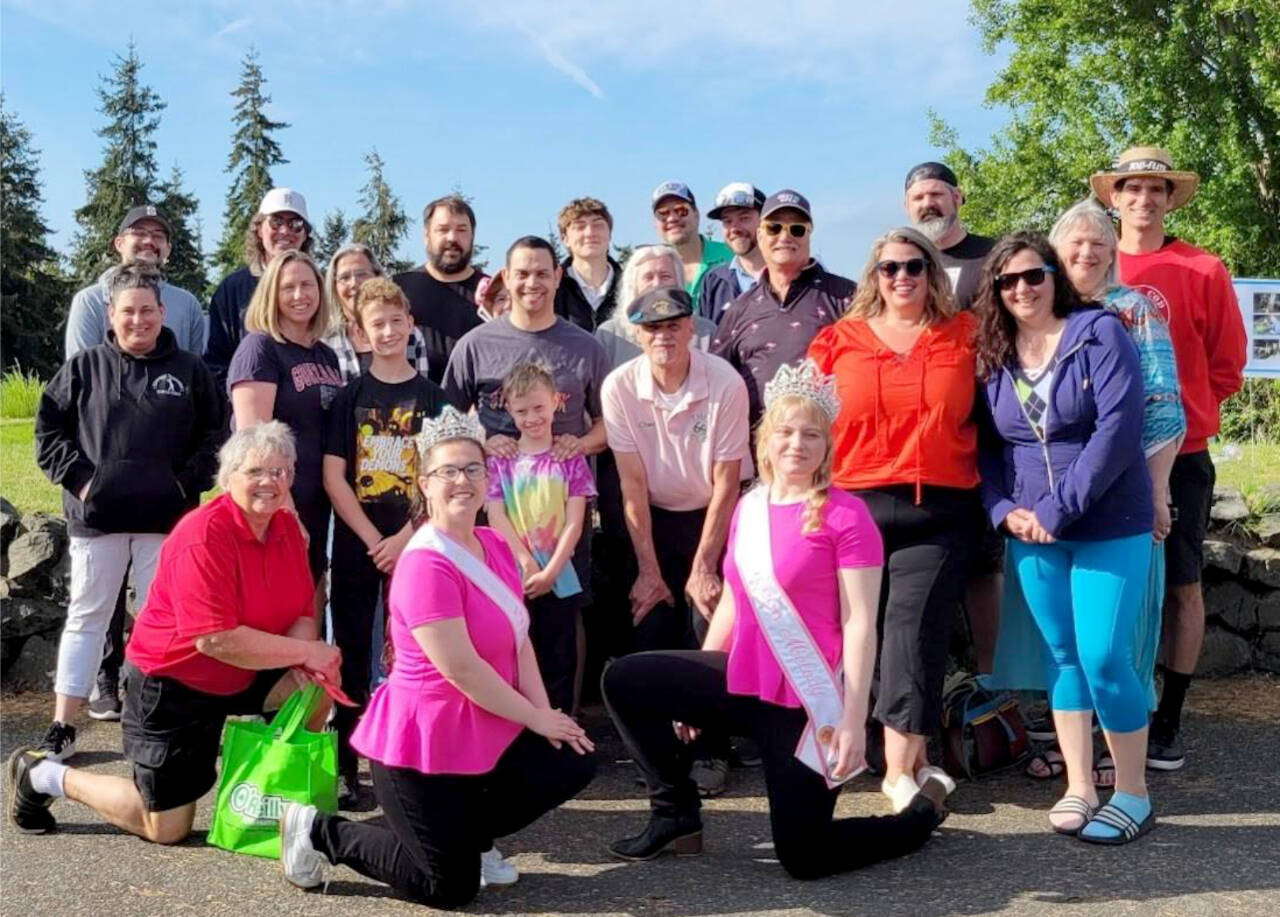 Caldwell, DeLeo and Beebe family members pose with Rhody Festival royalty at the Port Townsend Public Golf Course this weekend. Back row, from left are Chad Caldwell, Ron Wiley, Jim Beebe, Justice Beebe, Joey Beebe, Kelvin Kisner, Carlene Dahlman, Matt Dalman and Paul Dahlman. Middle row, from left are Leslie Shore, Danielle Babb, Karen Cartmel, Michael Babb, Tim Babb, James Babb, Pat Caldwell, Beth Caldwell (partial view), Tim Caldwell, Courtney Caldwell and Rebecca Beebe. Kneeling front, from left is Jim Caldwell, Memorial Rhody Festival Golf tournament organizer, Rita Beebe, Rhody Princess Paige Govia and Queen Melody Douglas.